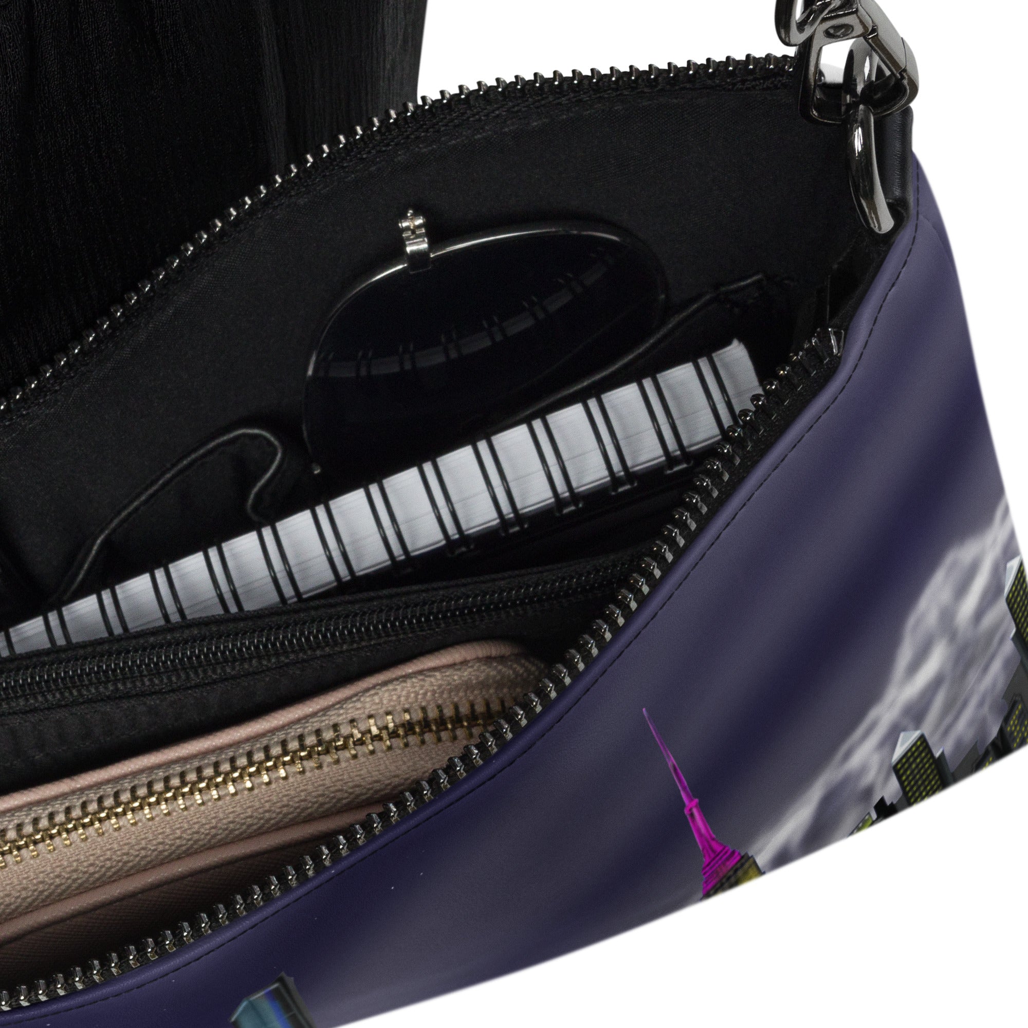 Open purple handbag with zipper details and a cityscape design.