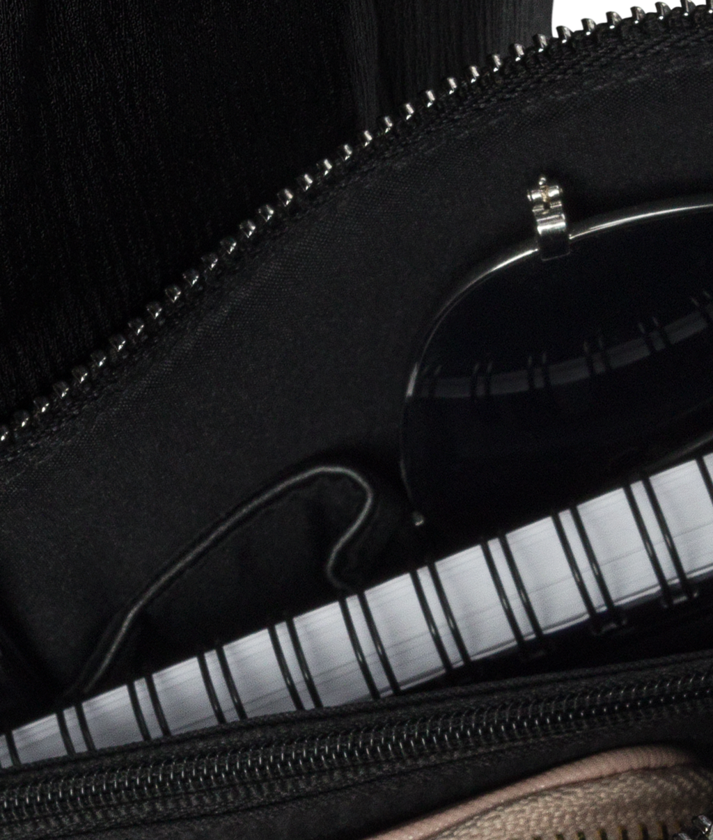 Close-up of a black suitcase with a zipper and handle