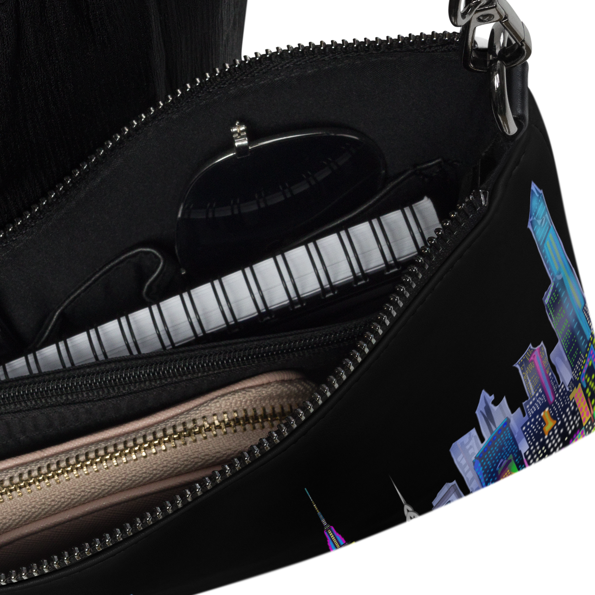 Black handbag with a partially open zipper, showing a Loria NYC Art cityscape design on the interior.