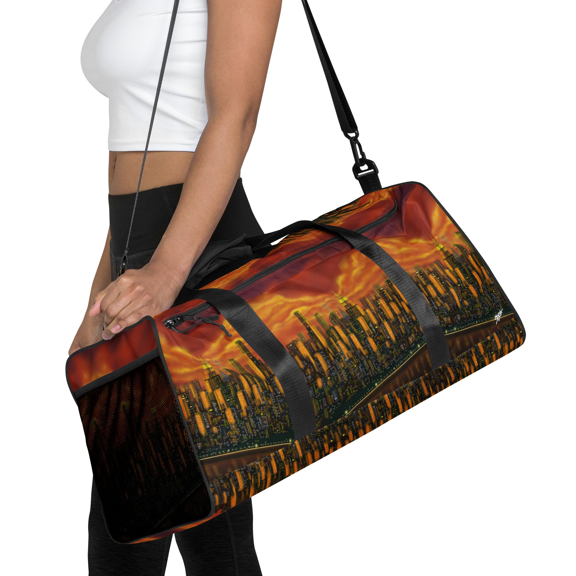 Duffle bag with cityscape design held by a person