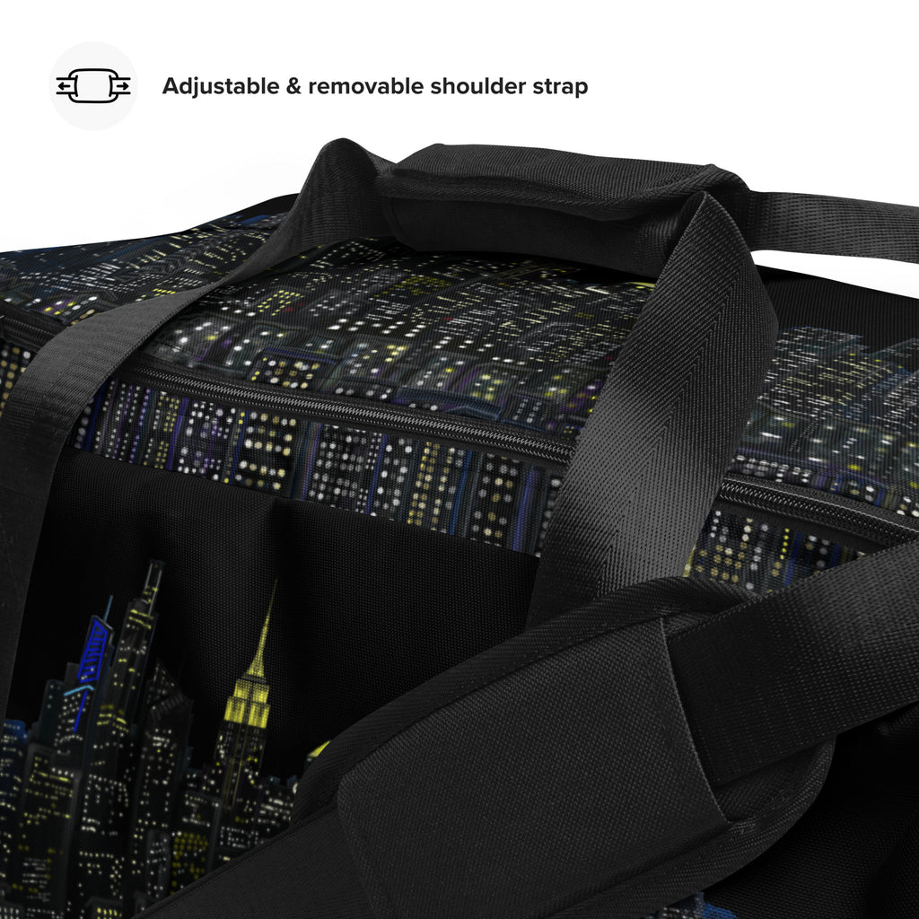 Black duffel bag with cityscape design and adjustable/removable shoulder strap on a white background