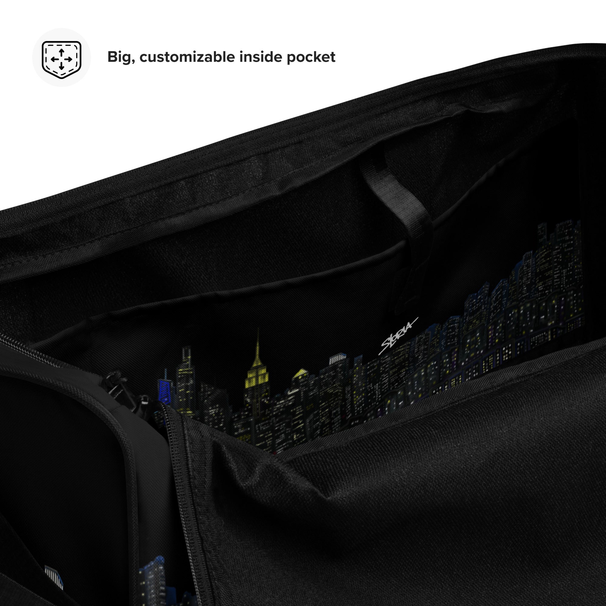 Black Loria NYC Art bag with a cityscape design on the inside pocket, featuring text 'Big, customizable inside pocket'.