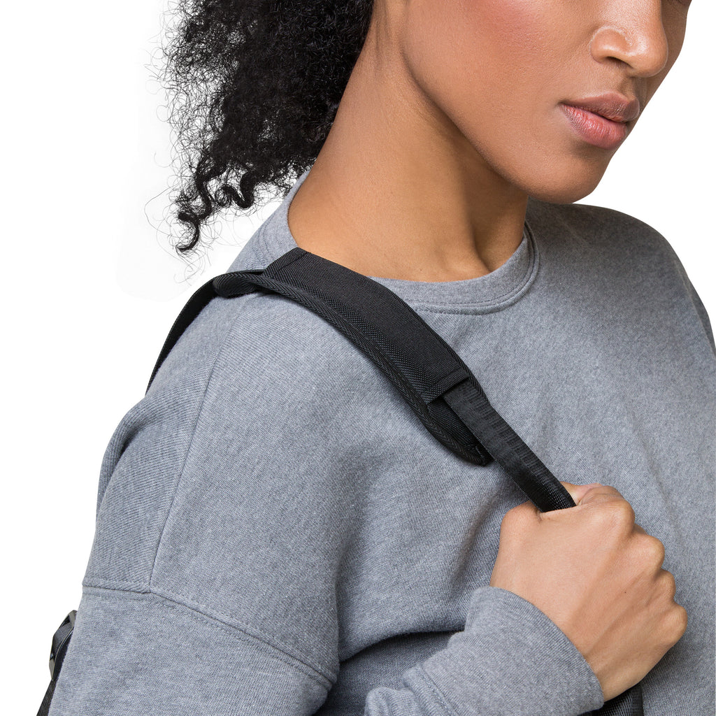 Person wearing a gray sweatshirt with a black strap over their shoulder on a white background