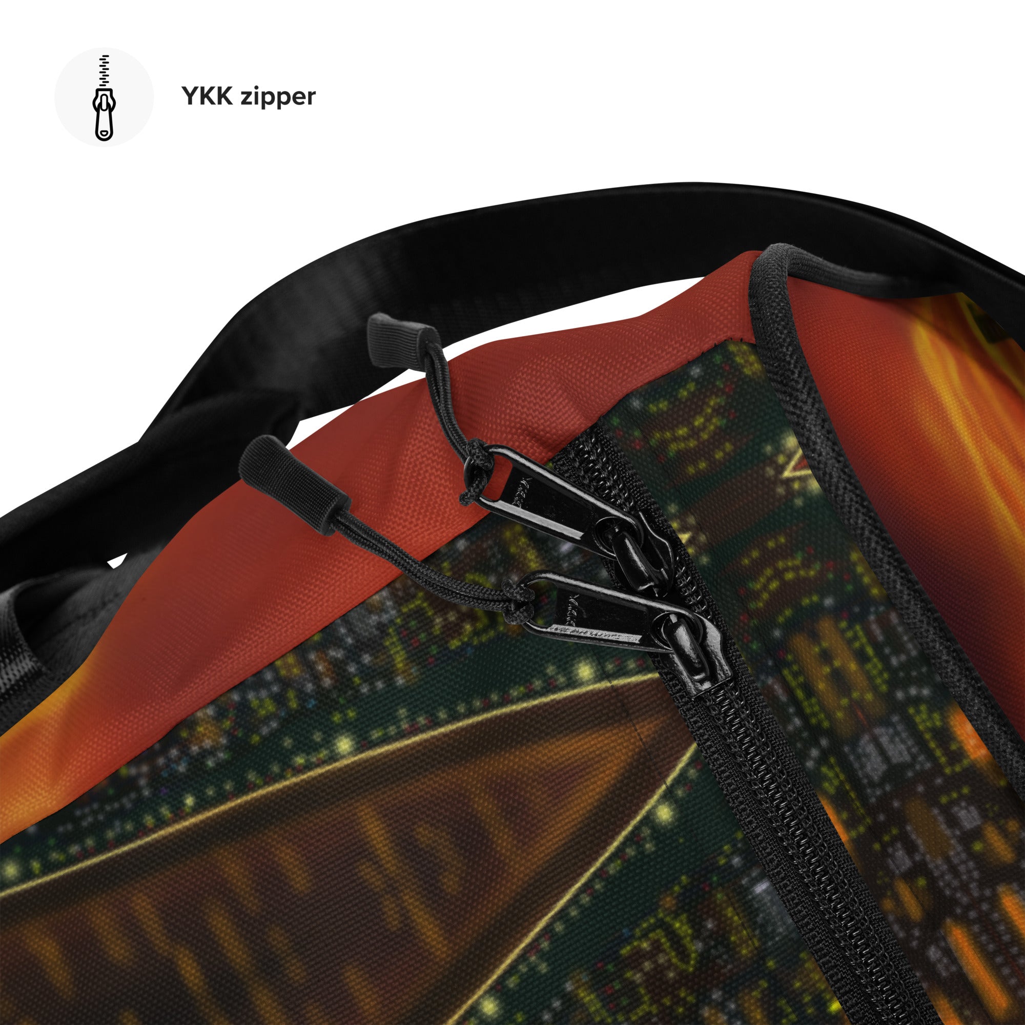 Close-up of a YKK zipper on a bag with a cityscape pattern.