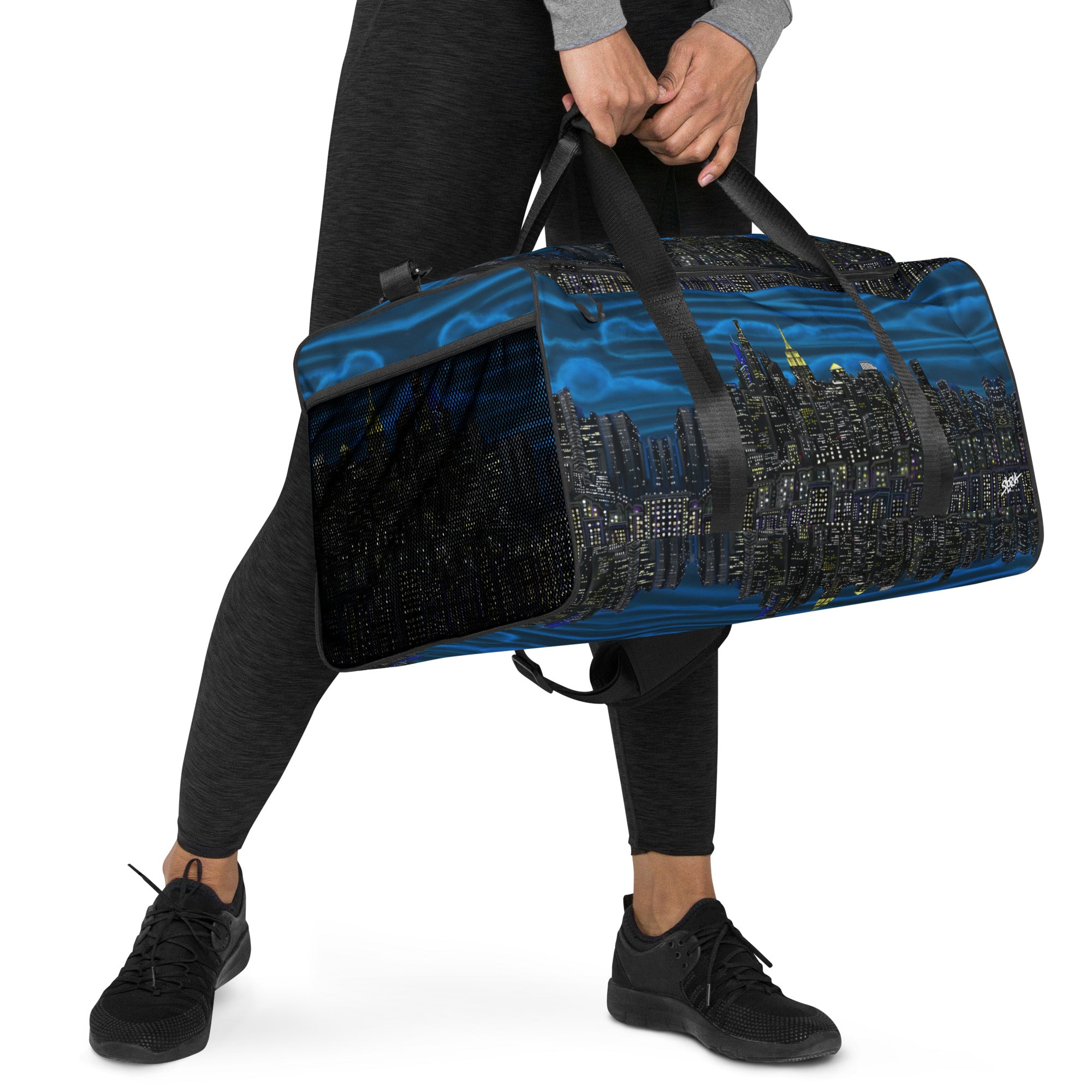 Lady carrying a Loria NYC Art designed duffle bag on  white background 