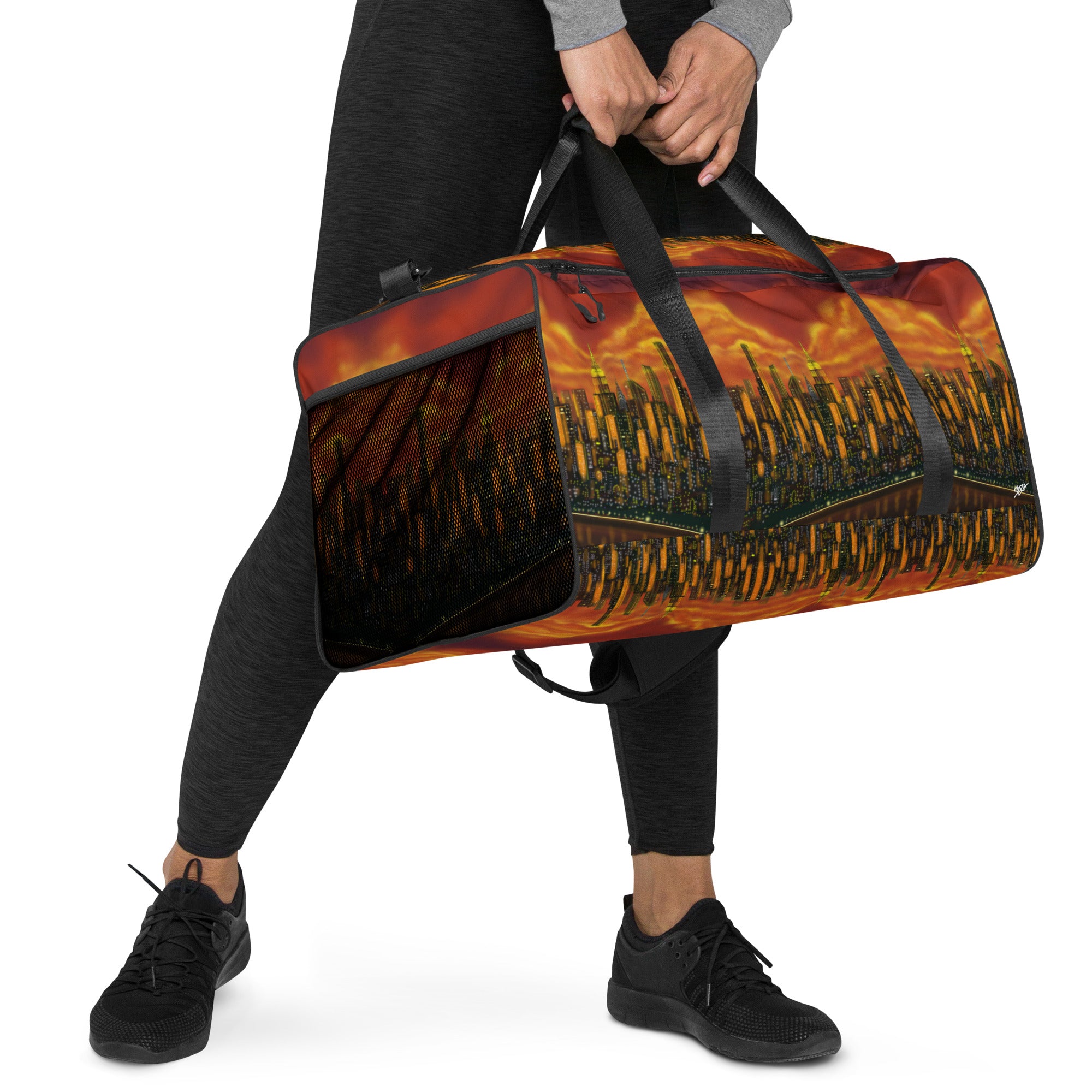 Person holding a duffel bag with a fiery design on a white background