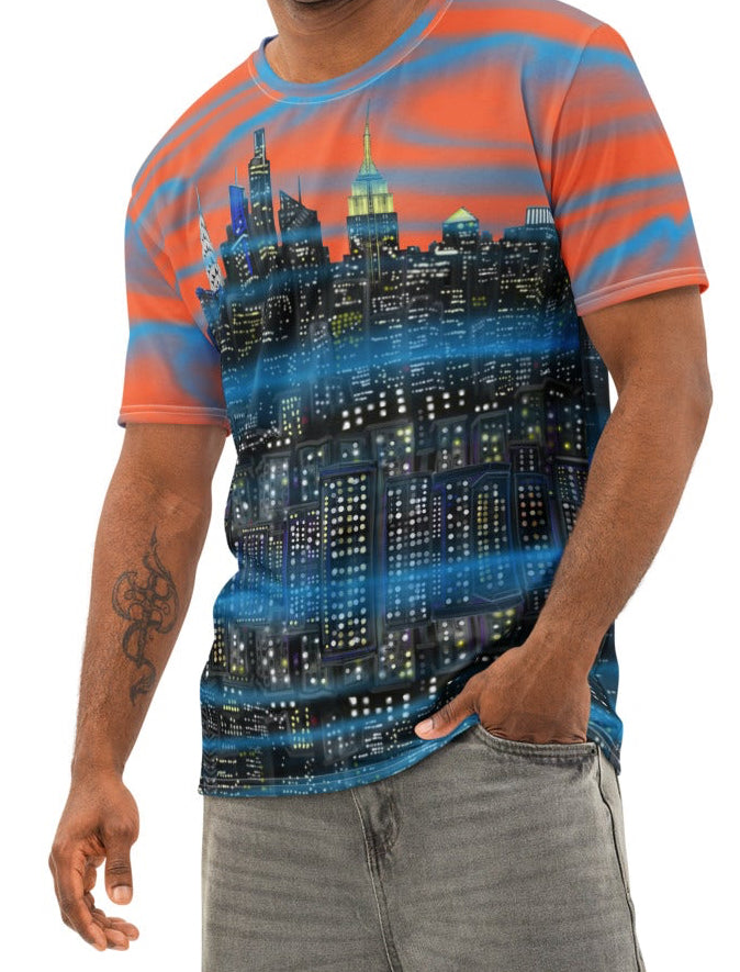Man wearing a colorful Loria NYC Art shirt and gray pants on a white background