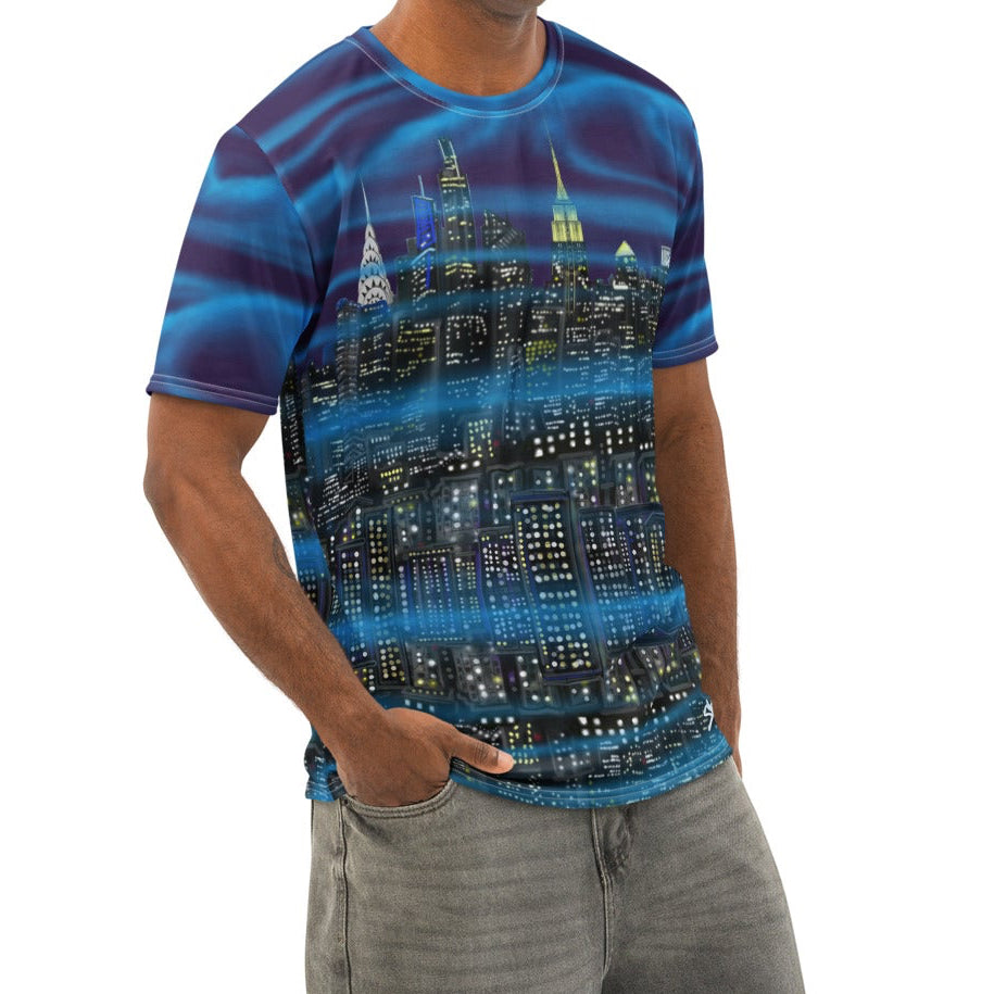 Man wearing a blue and purple Loria NYC Art shirt with gray pants on a white background
