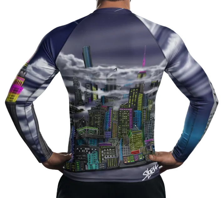 Man wearing a blue Loria NYC Art rash guard shirt on a white background.