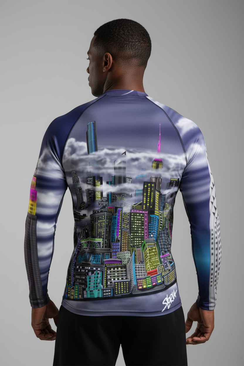 Person wearing a long-sleeve shirt with a Loria NYC Art cityscape design on a gray background
