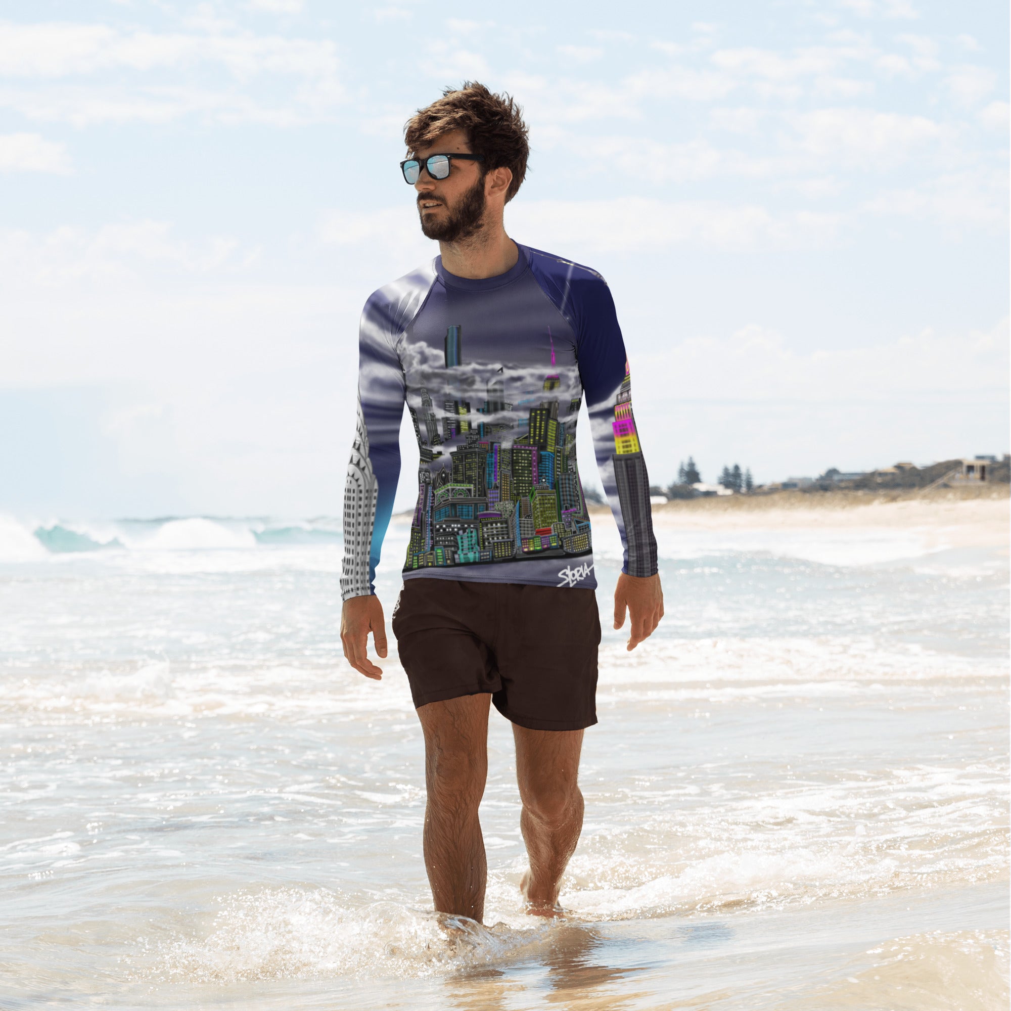 Man on beach wearing a Loria NYC Art athletic shirt on the beach