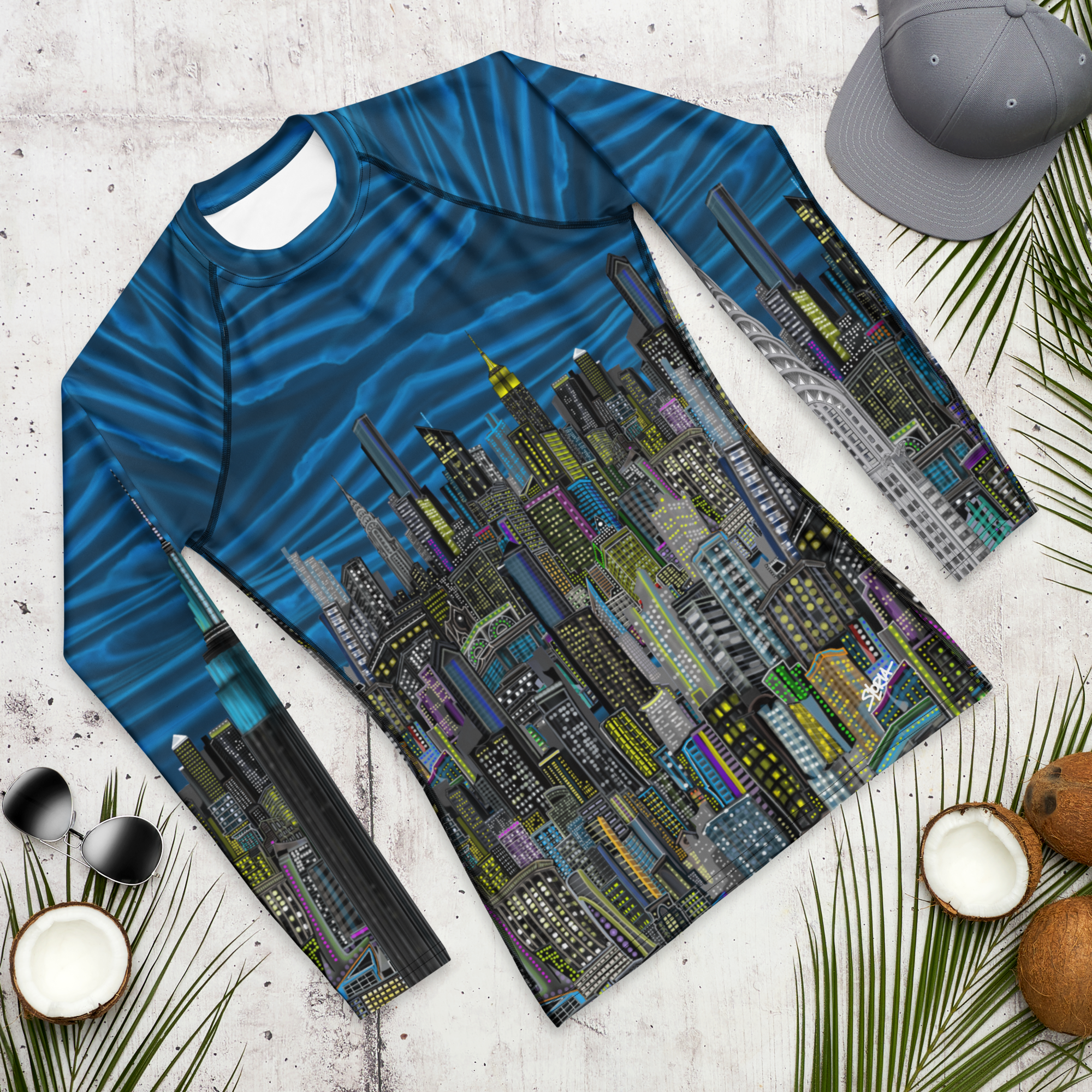 Long-sleeve shirt with  Loria NYC Art cityscape design on a textured surface with accessories.