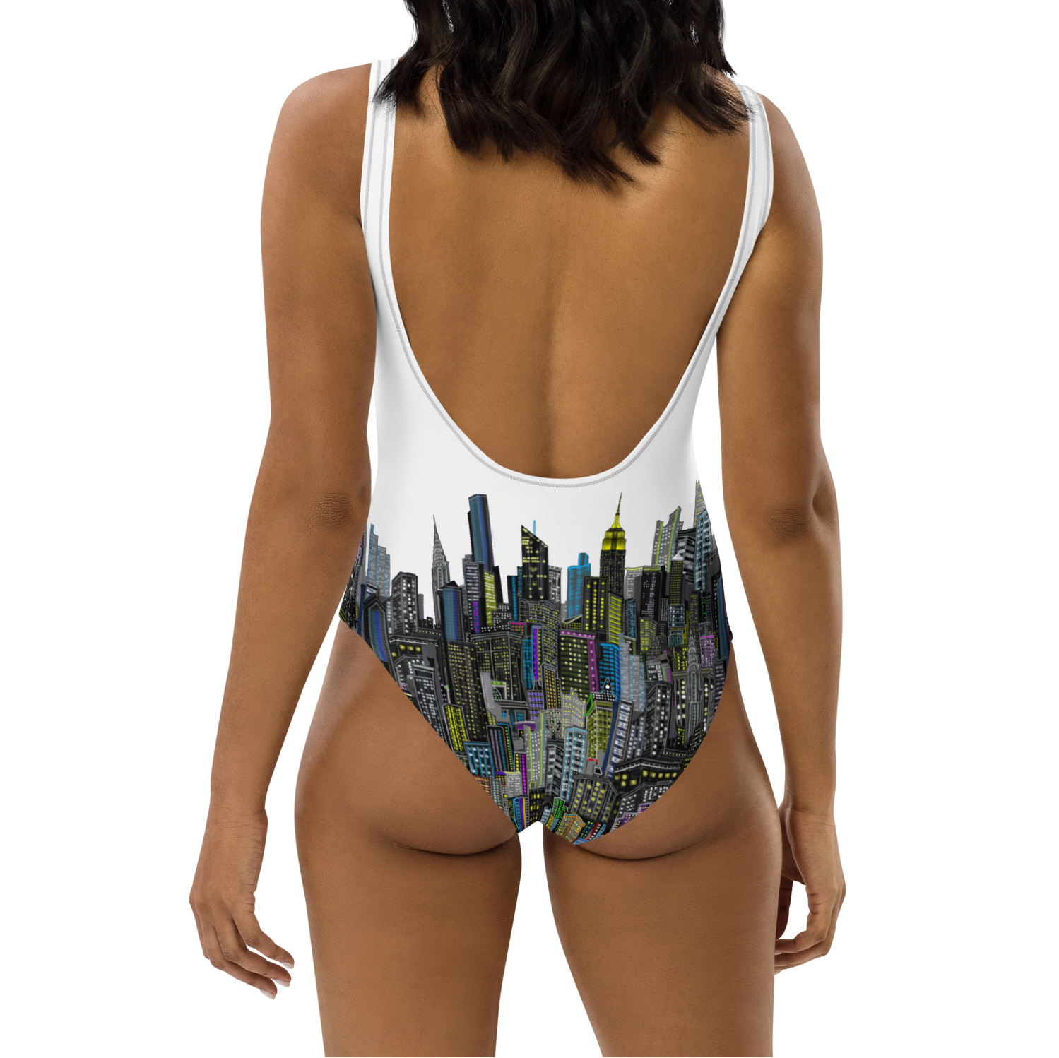 Woman wearing a Loria NYC Art swimsuit with a cityscape design on a white background
