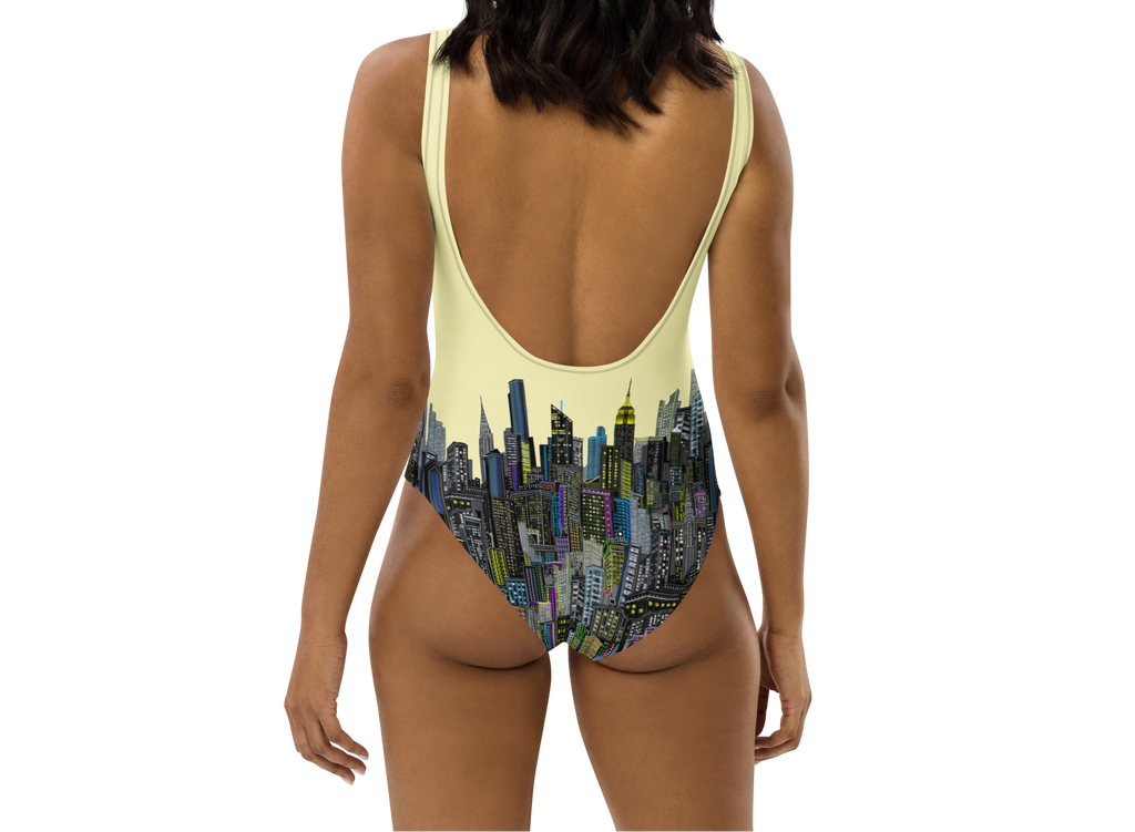 Woman wearing a swimsuit with Loria NYC Art cityscape design on a white background