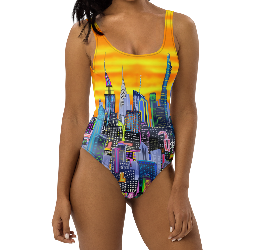 Woman wearing a colorful Loria NYC Art cityscape swimsuit on a white background