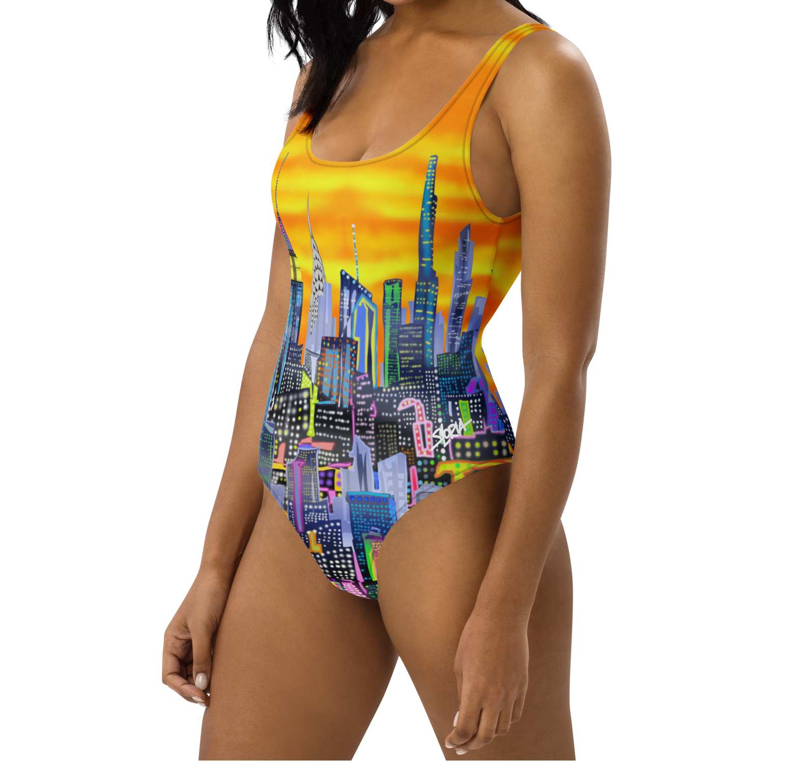 Woman wearing a colorful Loria NYC Art cityscape swimsuit on a white background