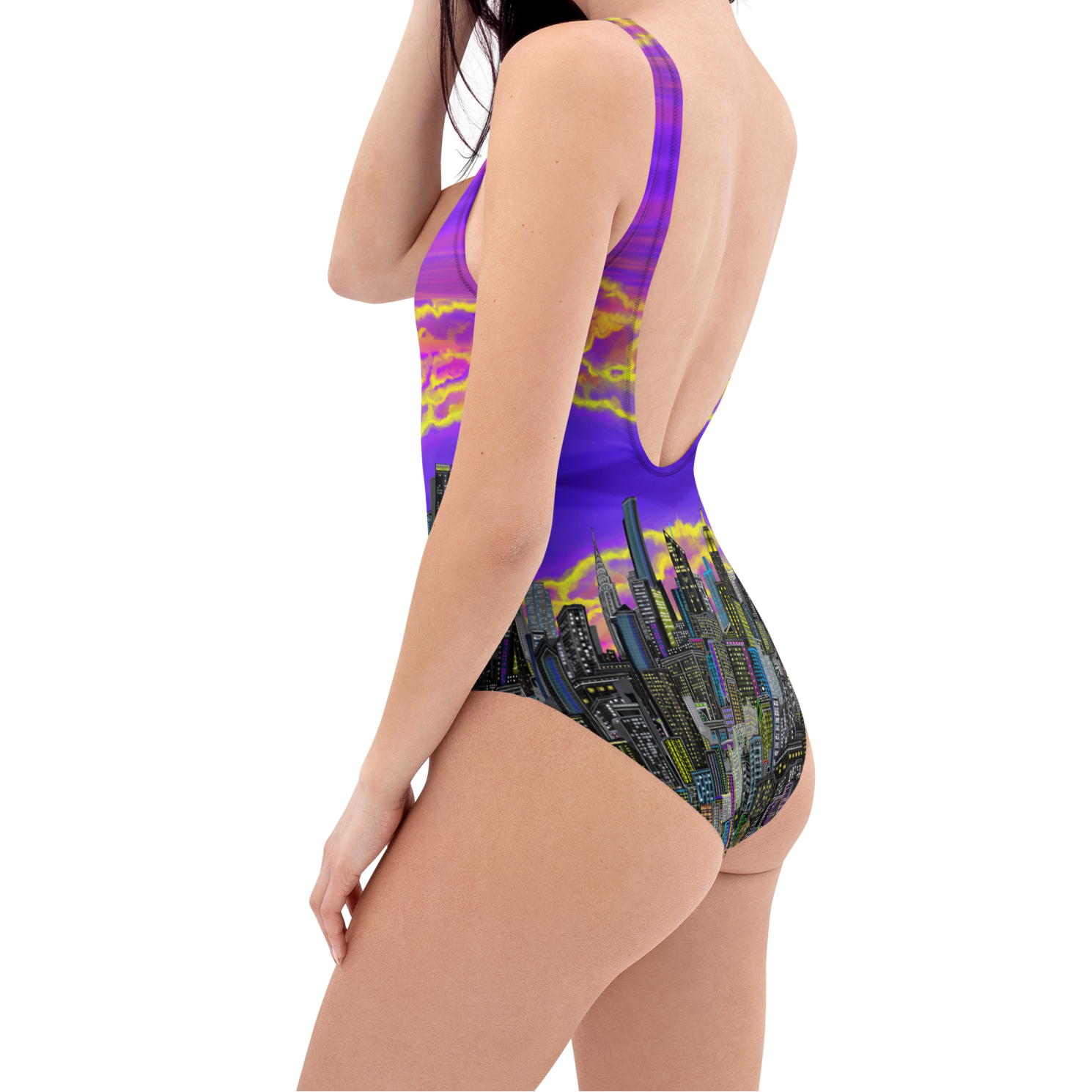 Woman wearing a colorful Loria NYC Art swimsuit with a cityscape design on a white background