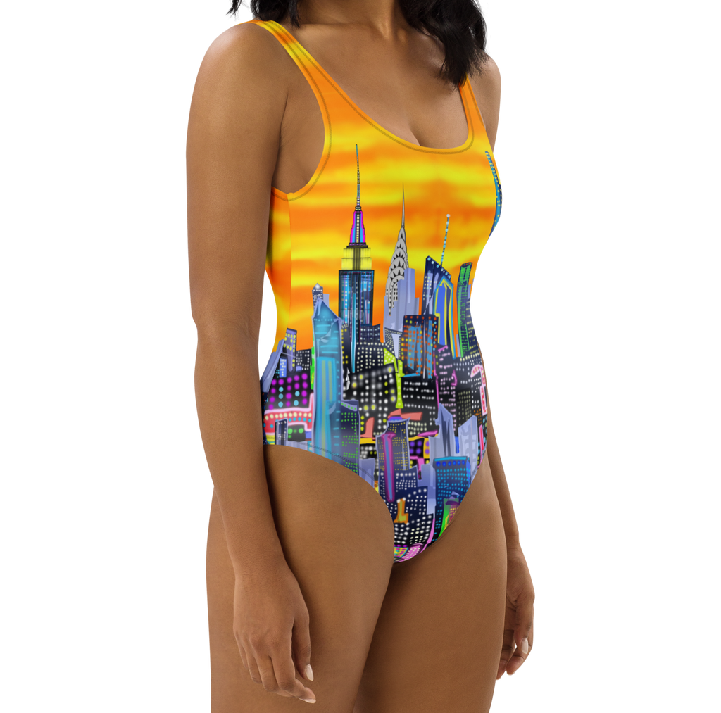 Lady wearing a Loria NYC Art colorful cityscape swimsuit on a white background
