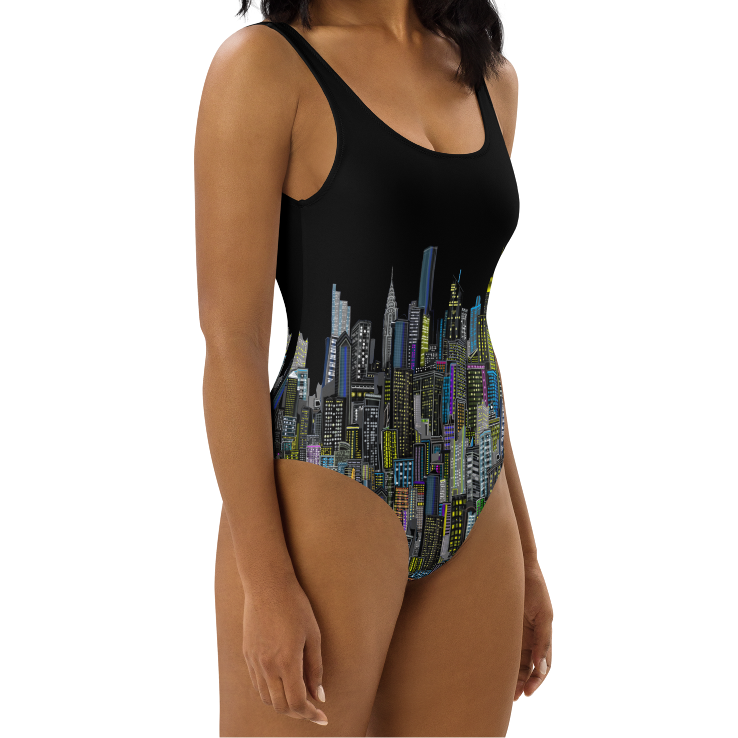 Woman wearing a Loria NYC Art black one-piece swimsuit with city skyline design on a white background