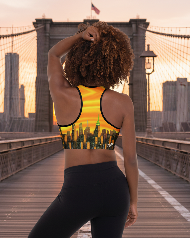 Person in athletic wear standing on a bridge with a city skyline in the background wearing a sports bra with a Sports Bra  Riflessi al Tramonto Skyline by Loria NYC Art 