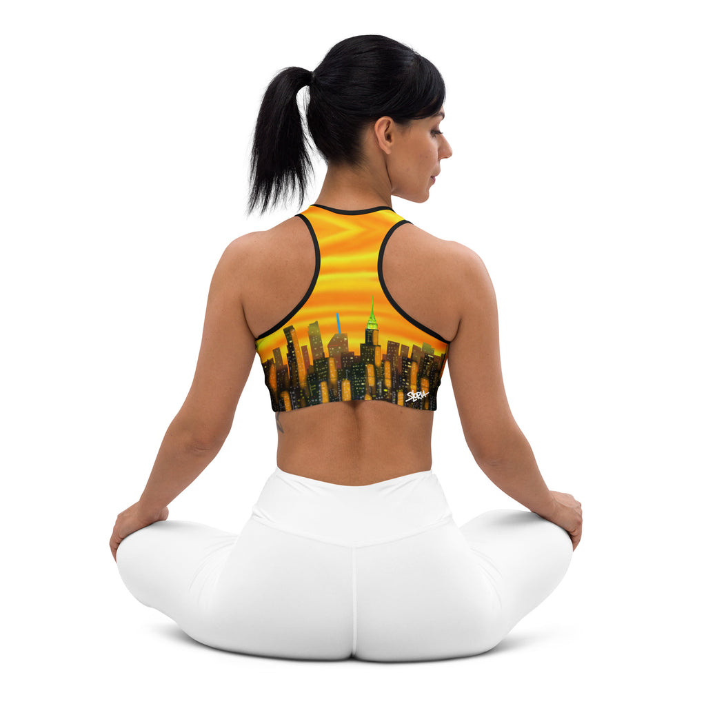 Woman wearing a sports bra with a Sports Bra  Riflessi al Tramonto Skyline by Loria NYC Art cityscape design on a white background