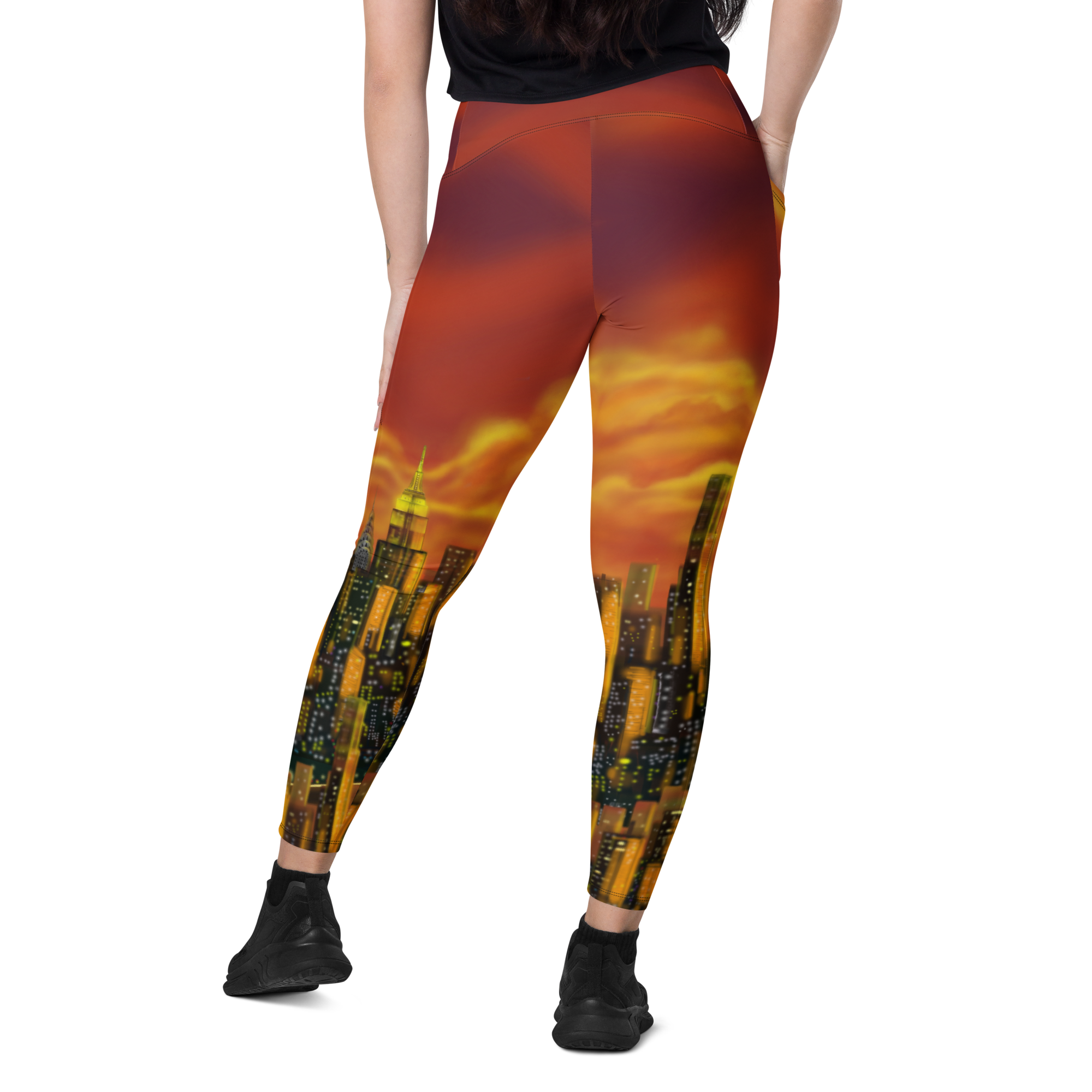 Leggings with a Loria NYC Art cityscape design featuring a sunset, worn by a person on a white background.
