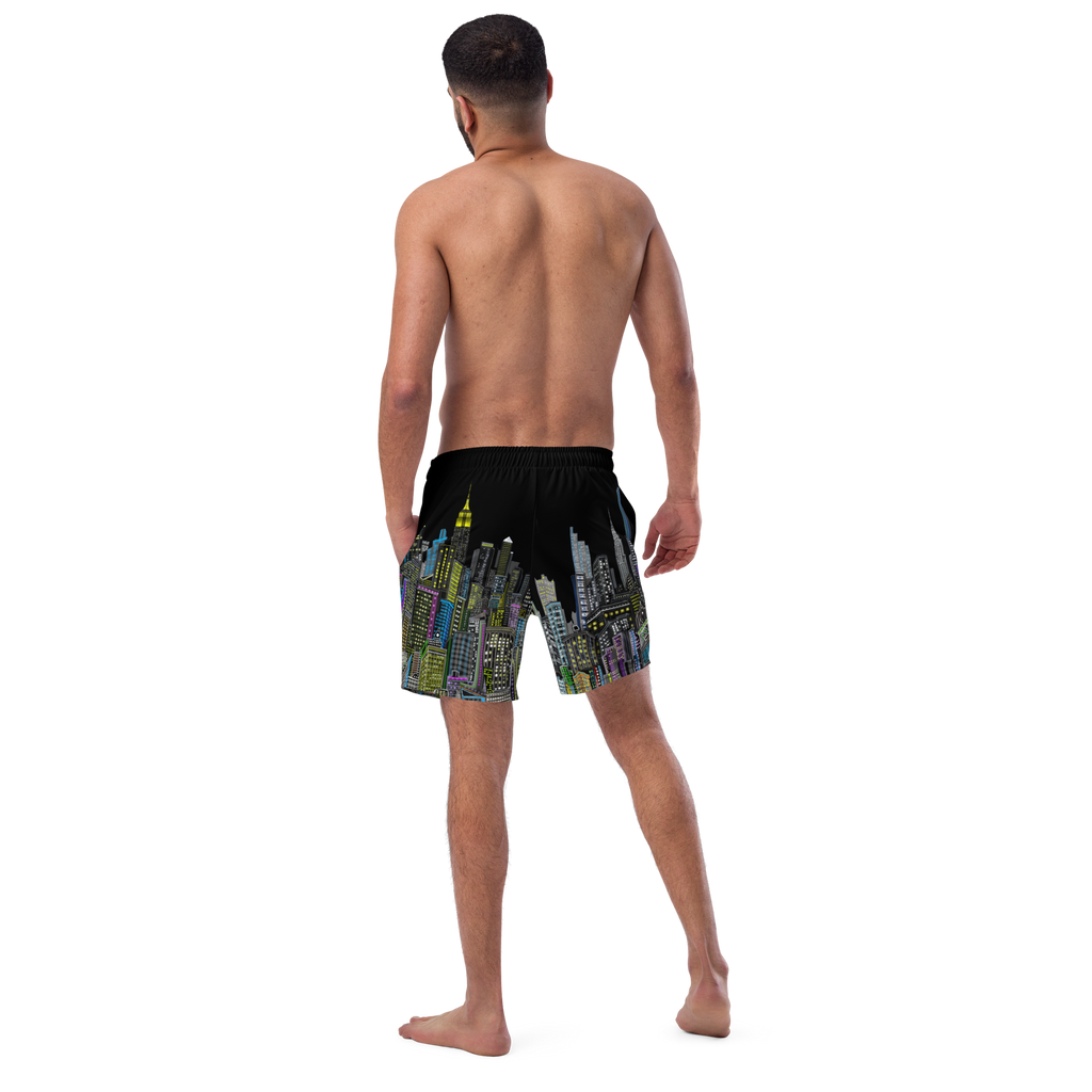 Man wearing black swim shorts with colorful Loria NYC Art cityscape design on a white background