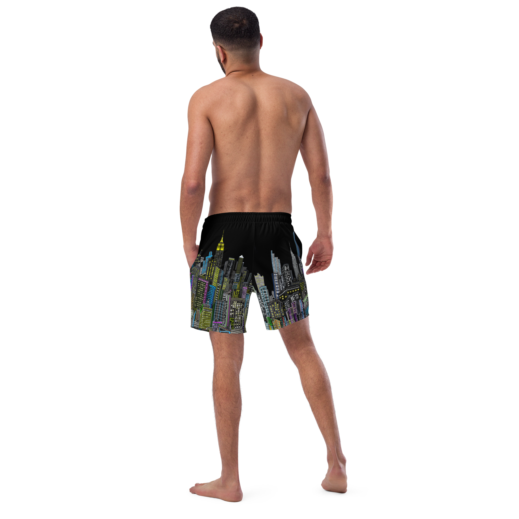Man wearing black swim shorts with colorful Loria NYC Art cityscape design on a white background