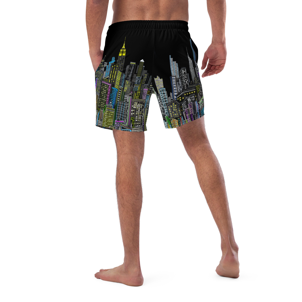Black swim shorts with colorful cityscape Loria NYC Art design worn by a person on a white background