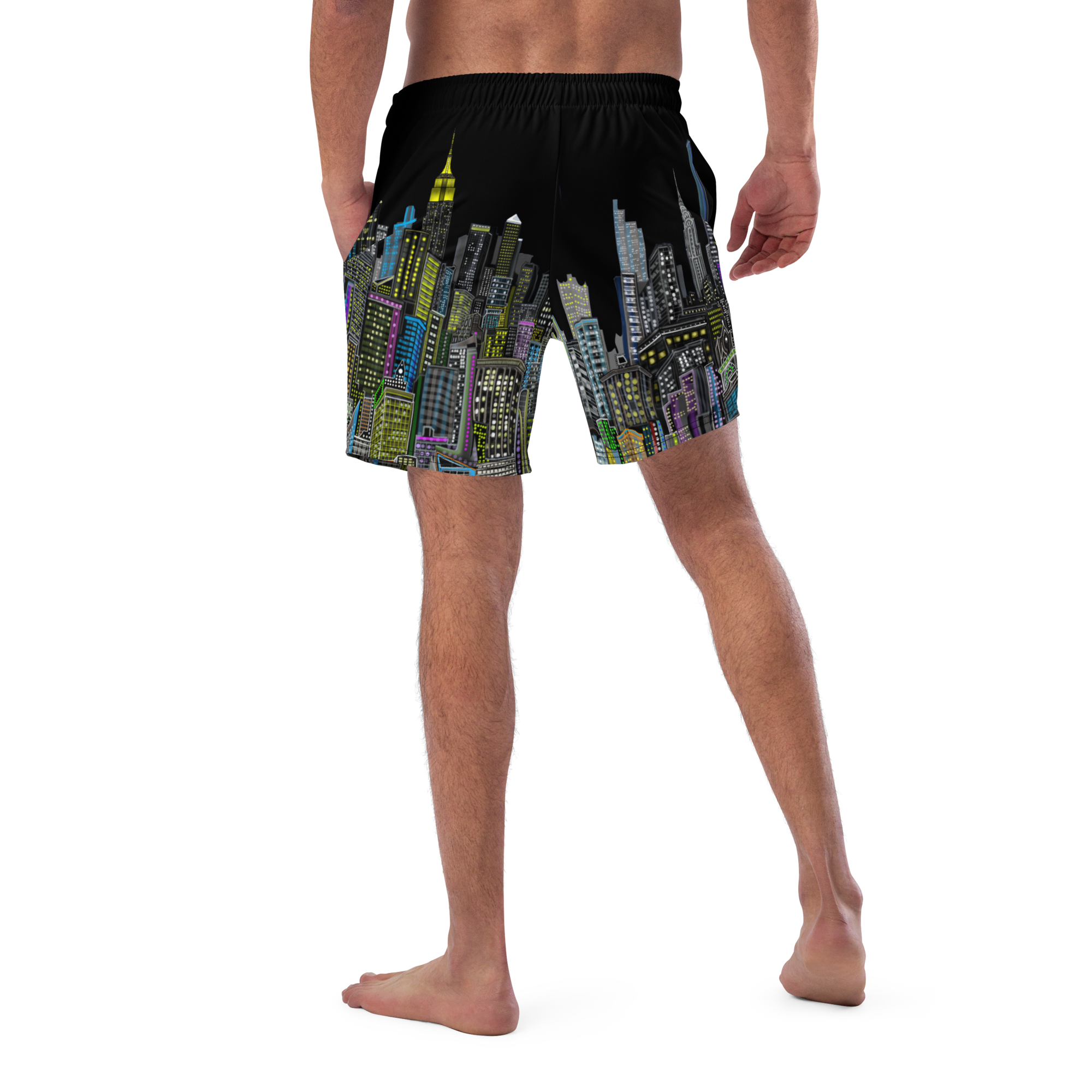 Black swim shorts with colorful cityscape Loria NYC Art design worn by a person on a white background