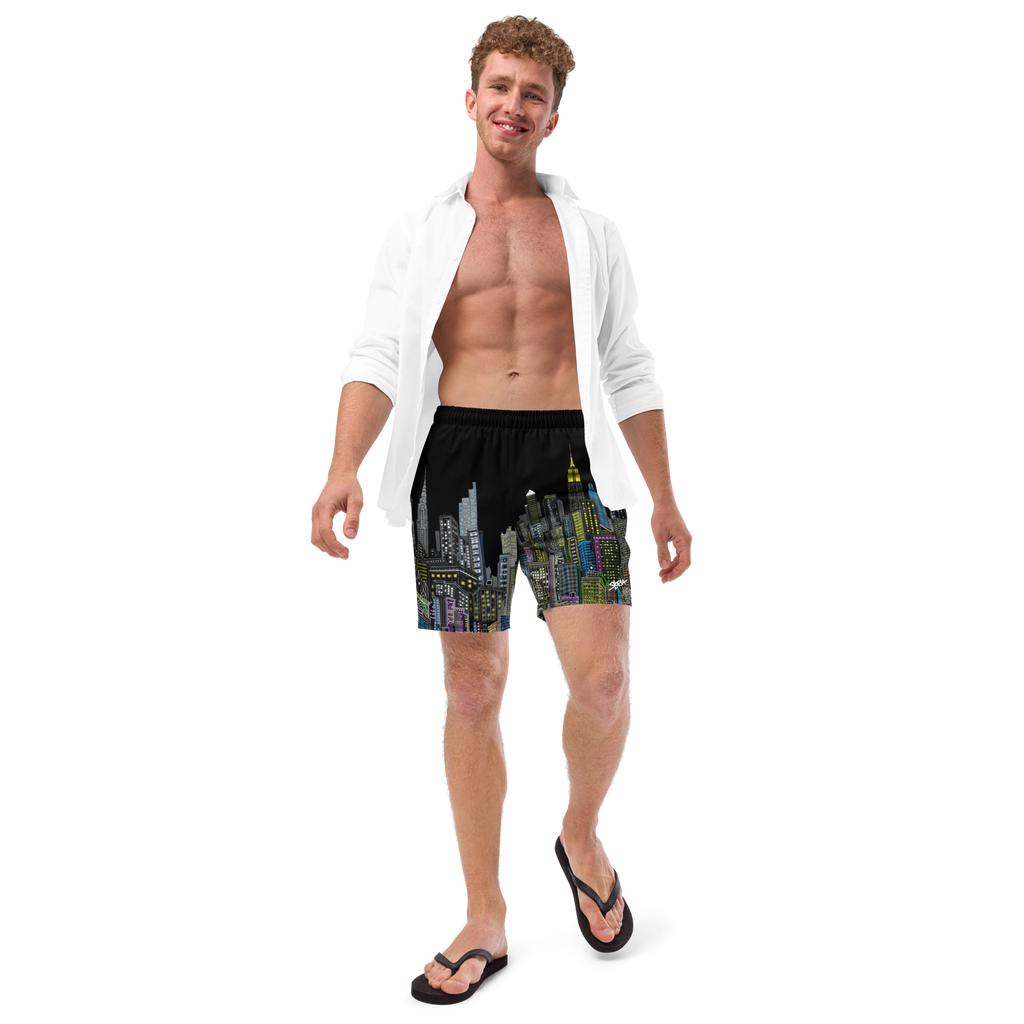 Man wearing black swim shorts with a cityscape Loria NYC Art design on a white background