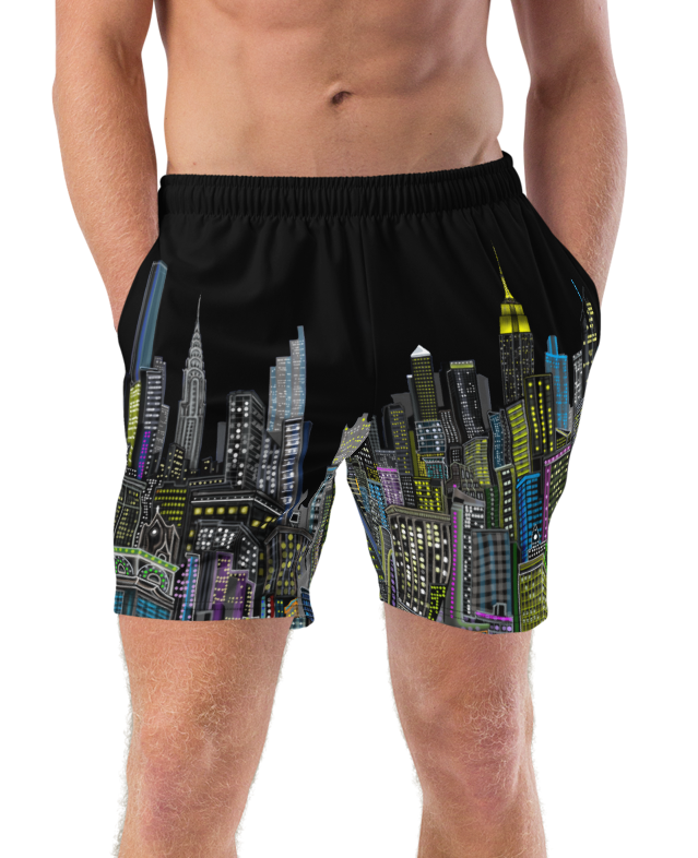 Man wearing black Loria NYC Art swim shorts with cityscape design on a white background
