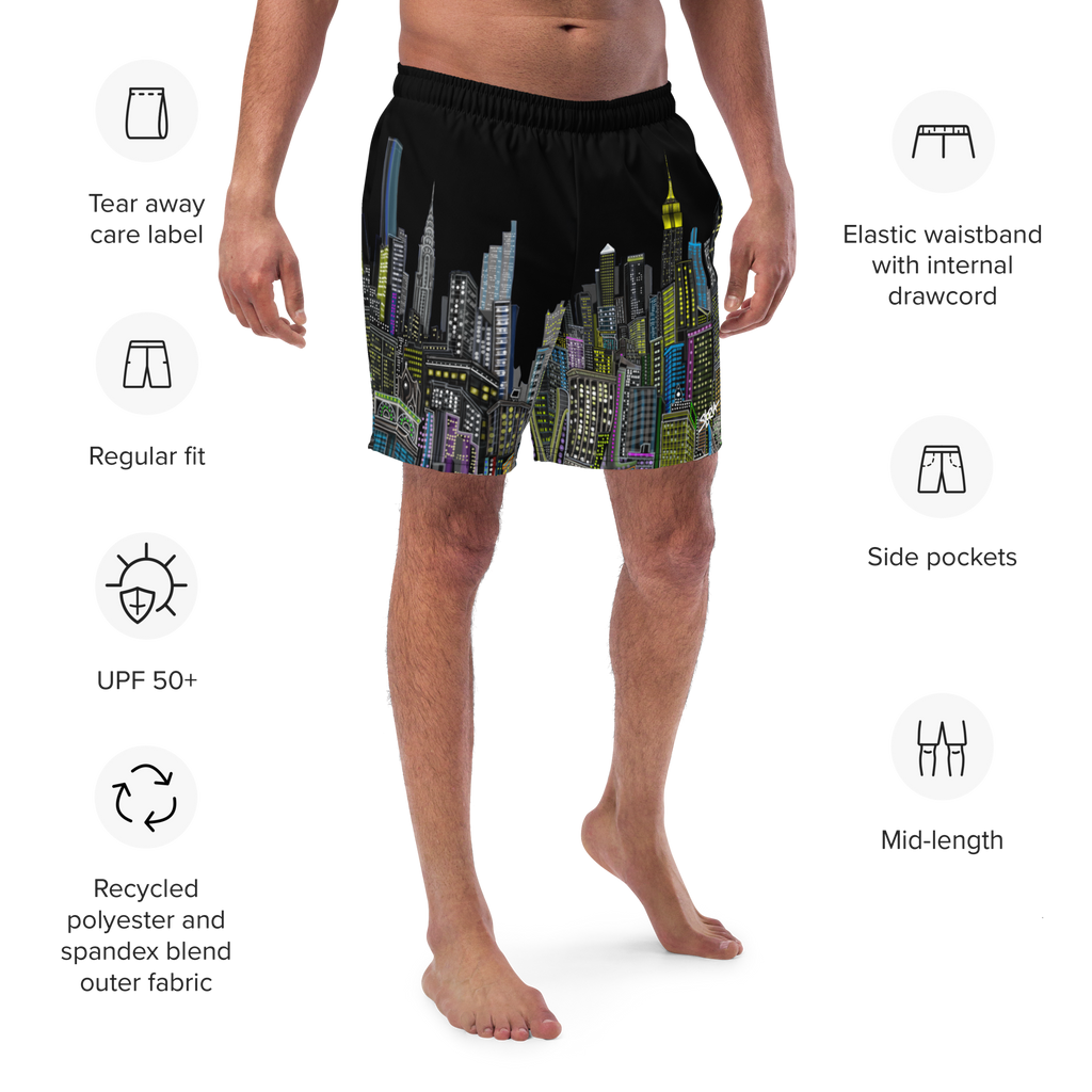 Man wearing black Loria NYC Art swim shorts with colorful cityscape design, featuring text labels on a white background.