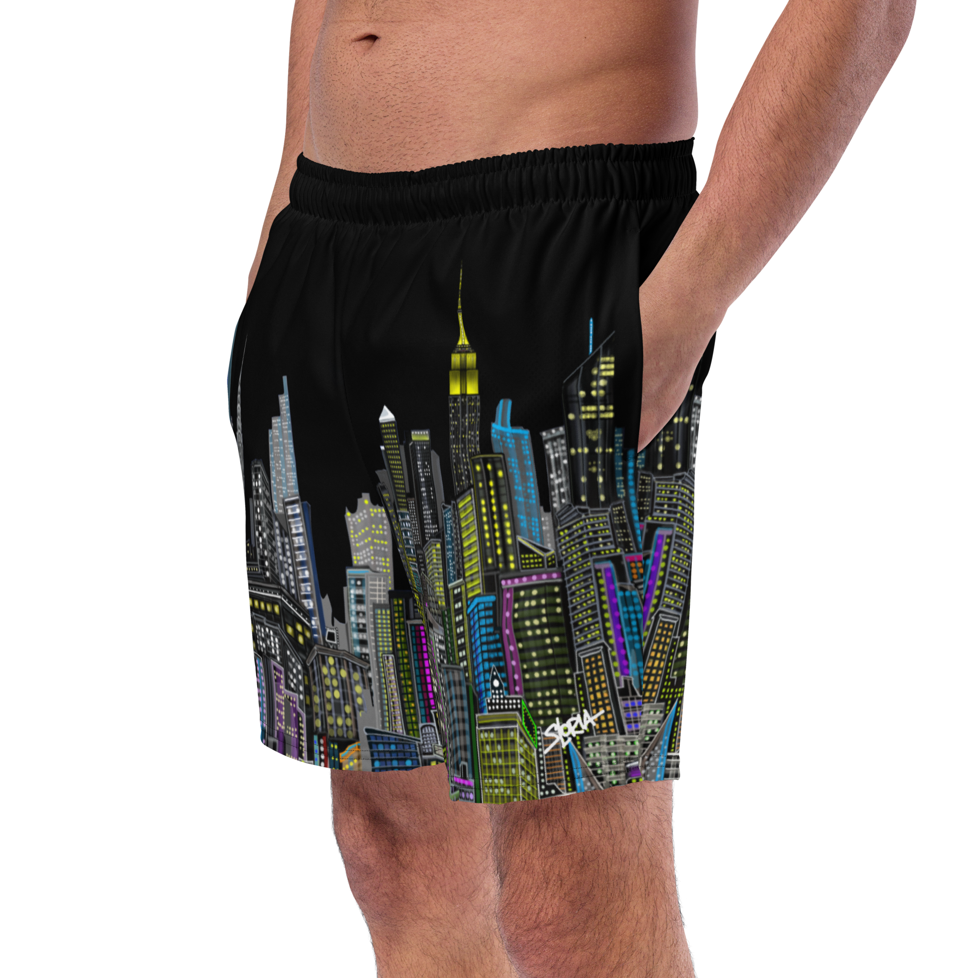 Black shorts with colorful Loria NYC Art cityscape design worn by a person on a white background