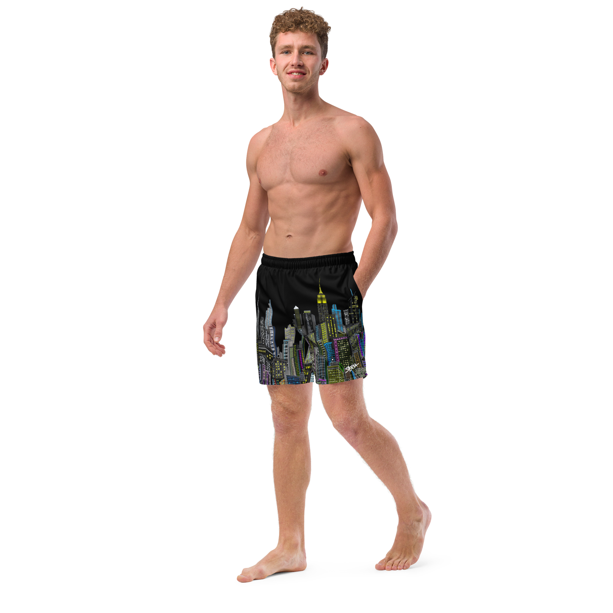 Man wearing black swim shorts with colorful Loria NYC Art cityscape design on a white background