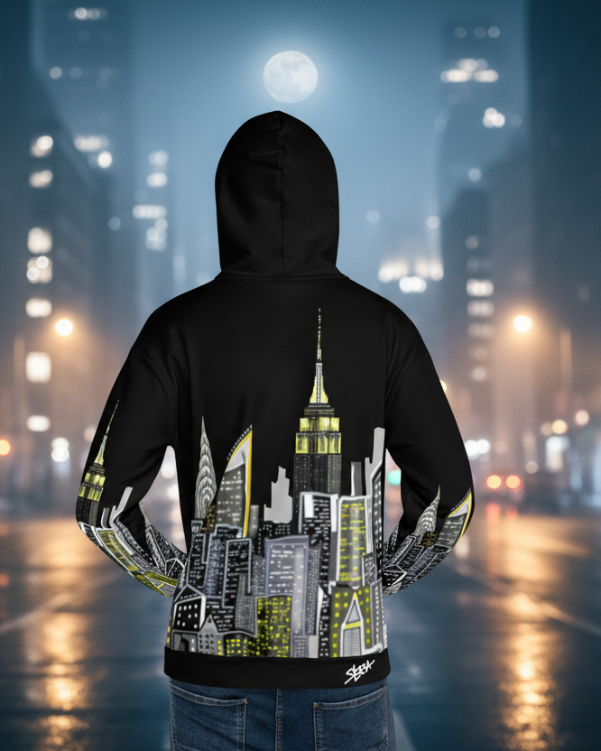 Person wearing a hoodie with a Loria NYC Art cityscape design on a city street at night.
