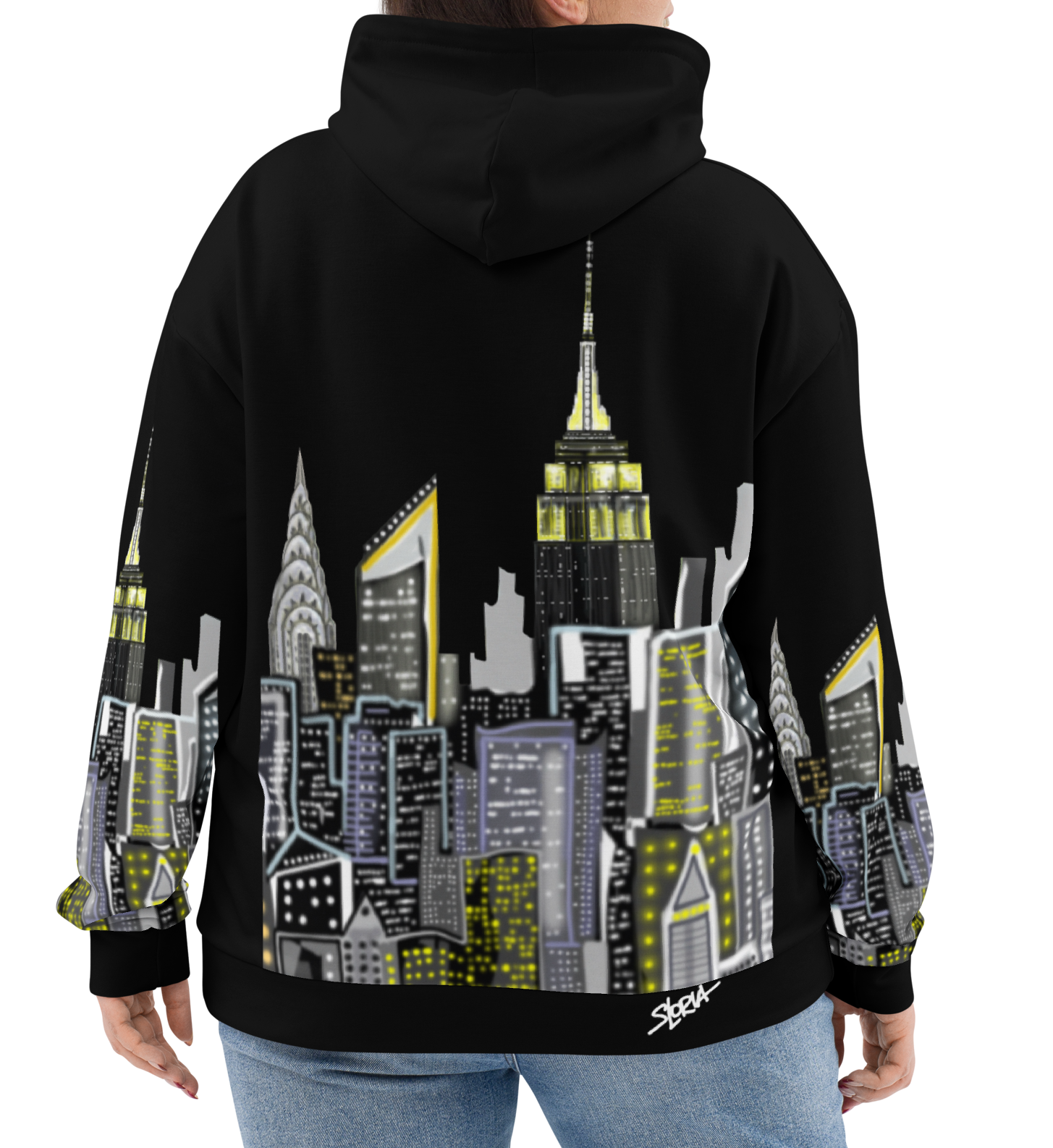 Person wearing a black hoodie with a cityscape Loria NYC Art design on the back, standing against a white background.