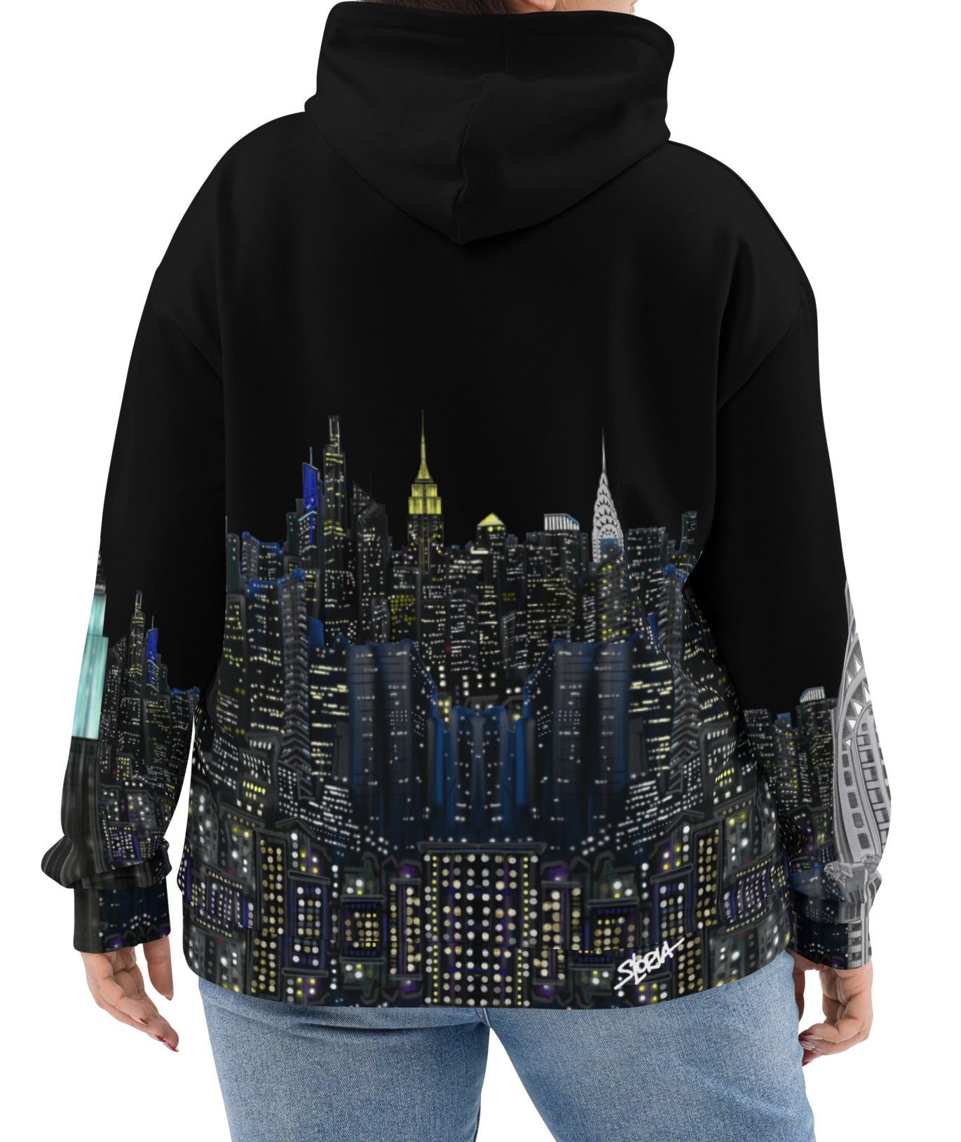 Person wearing a black hoodie with a cityscape Loria NYC Art design on the back, on a white background