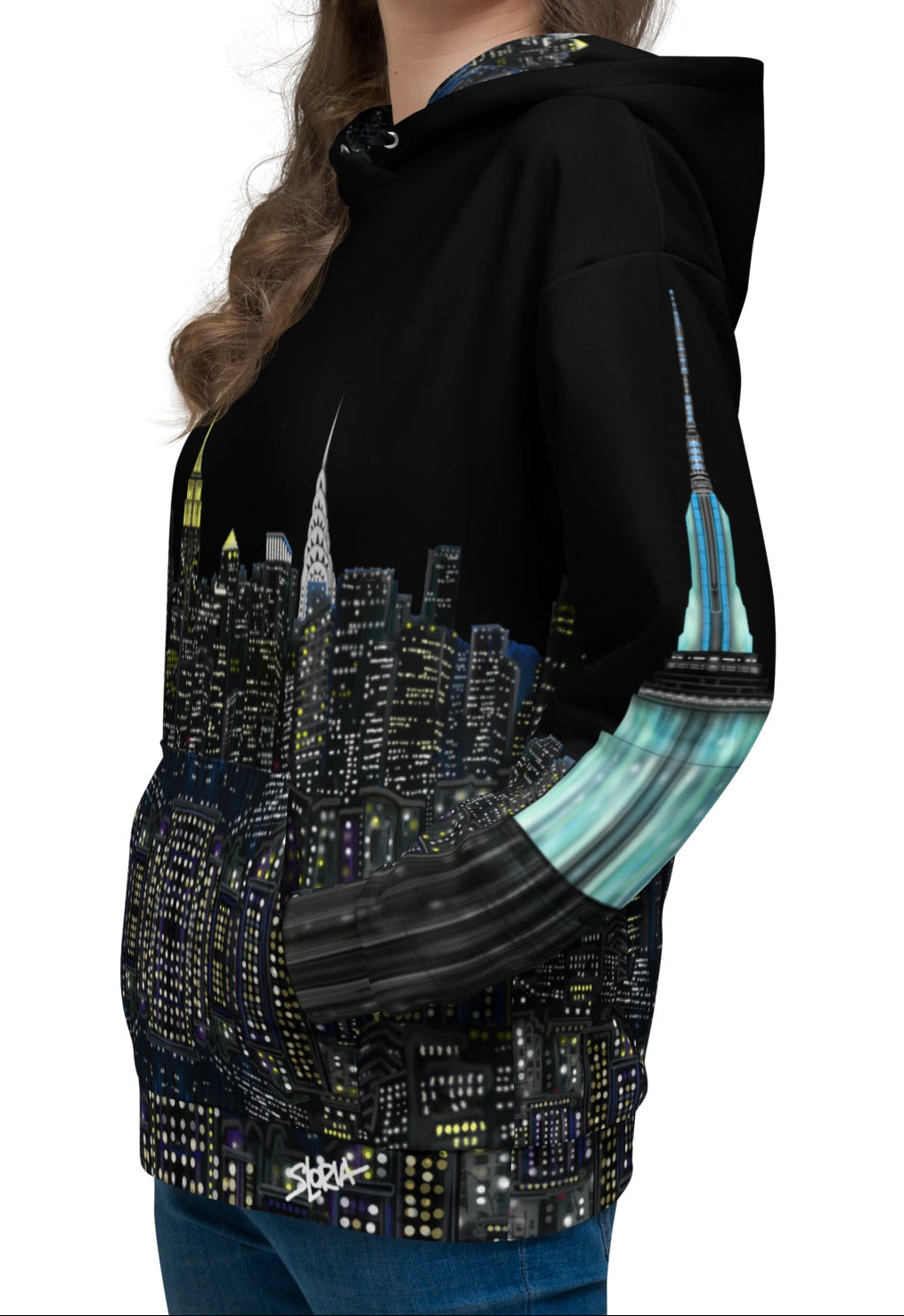 Woman wearing a black hoodie with a Loria NYC Art cityscape design on a white background