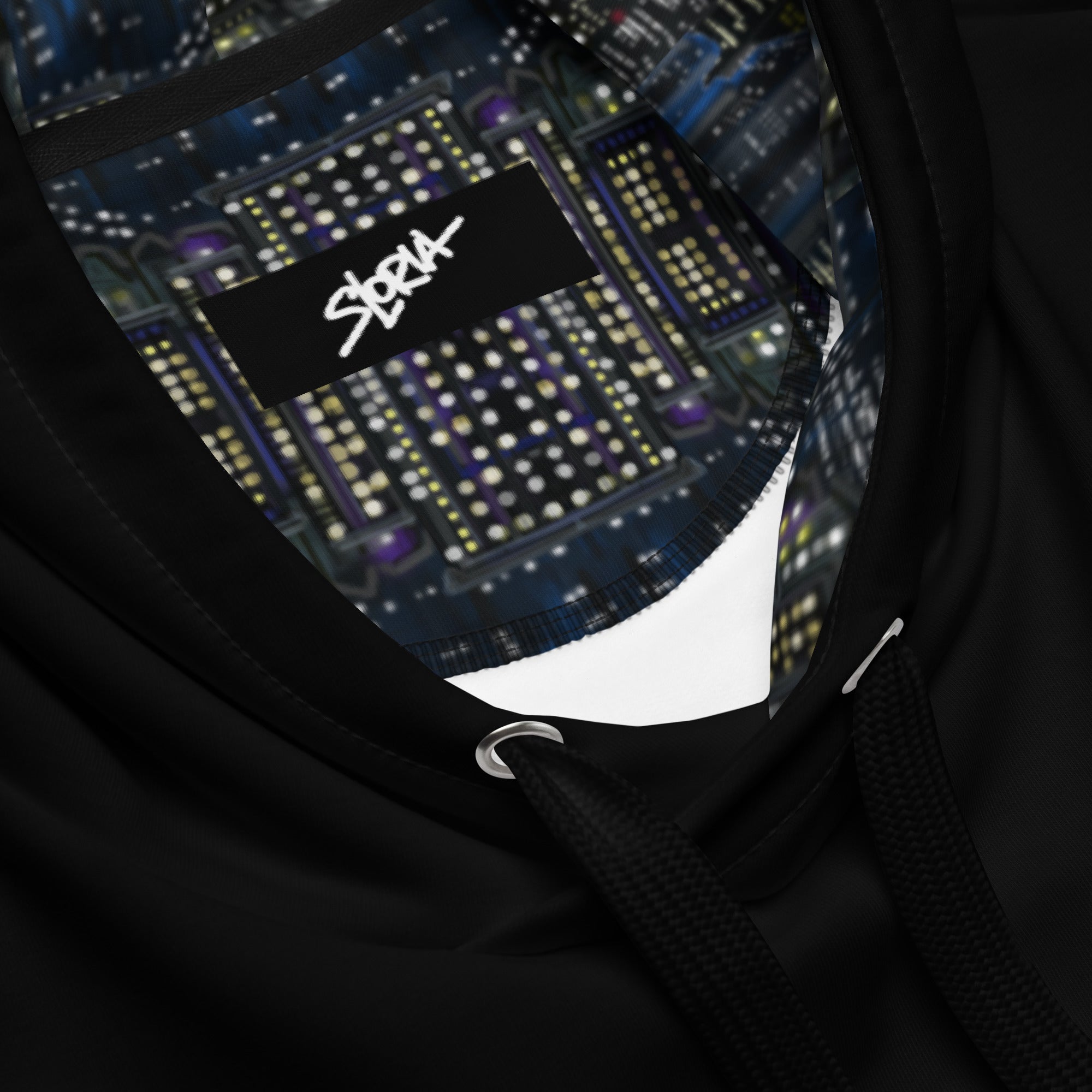 Close-up of a black hoodie with a reflective 'S.Loria' logo on a dark background