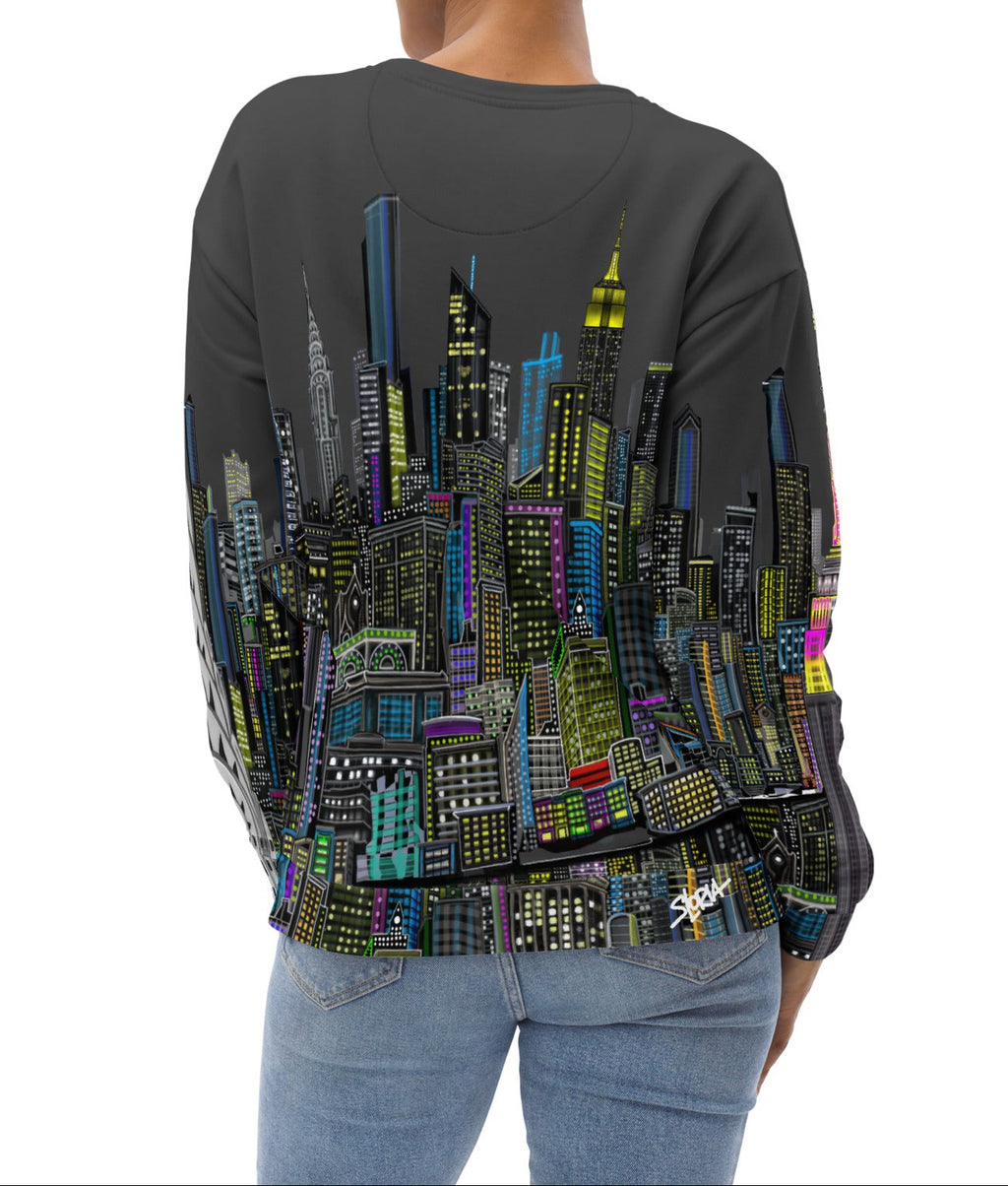 Rear of Female showing font side view  of Sweatshirt with a charcoal grey sky colorful cityscape design by Loria NYC Art on a white background