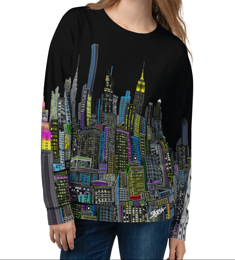Girl wearing a black sweatshirt with a colorful cityscape design by Loria NYC Art on a white background