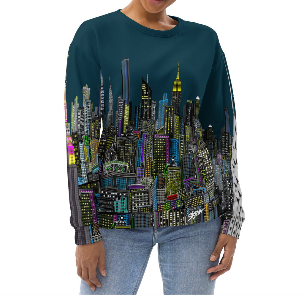 Girl wearing a long-sleeve blue shirt with a cityscape design by Loria NYC Art on a white background