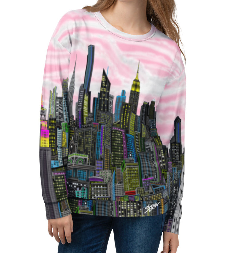 Person wearing a colorful Loria NYC Art cityscape sweatshirt with a pink and white pattern.