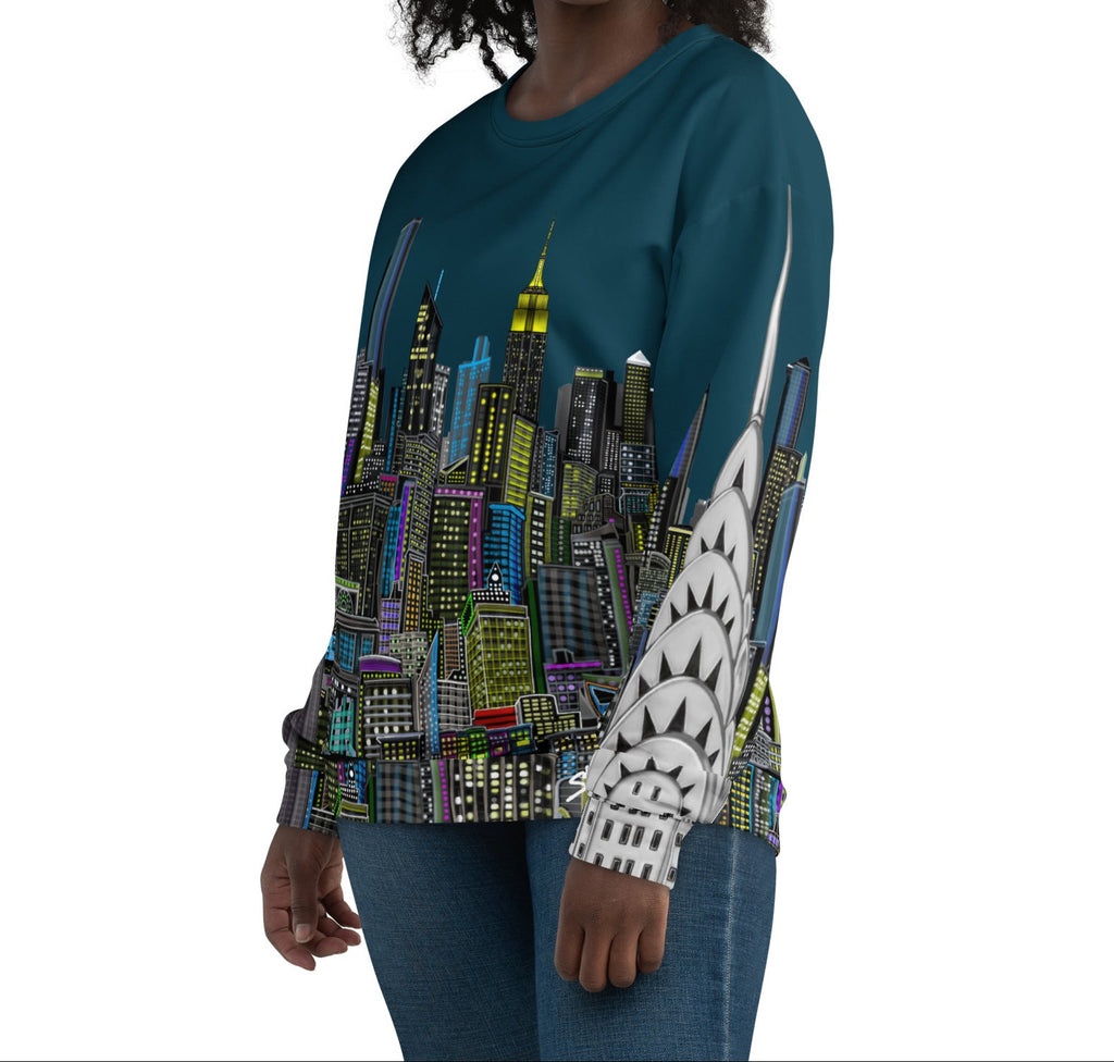 Woman wearing a teal sweatshirt with a colorful cityscape design by Loria NYC Art on a white background