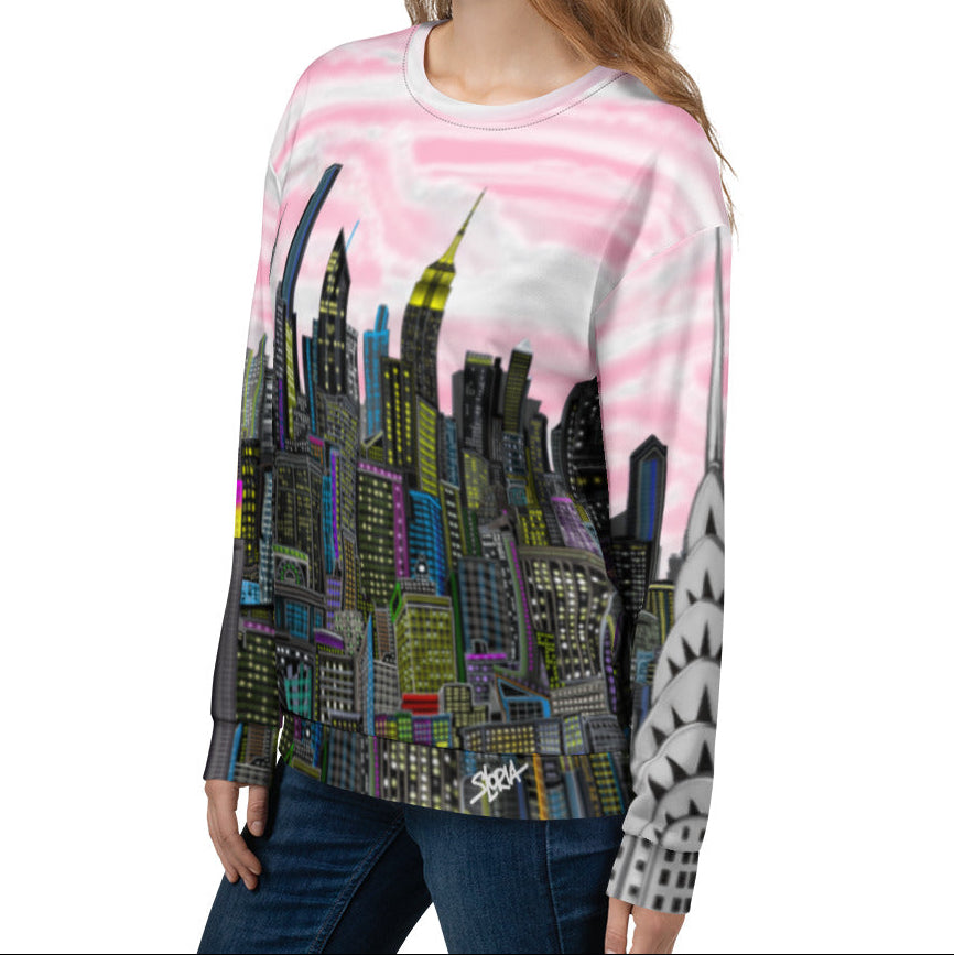 Person wearing a sweatshirt with a colorful cityscape design by Loria NYC Art on a white background