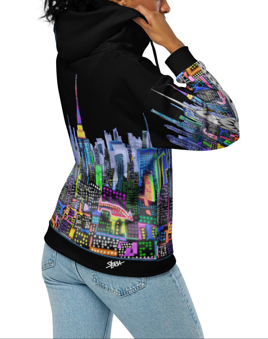 Girl holding holding Black hoodie with colorful cityscape design by Loria NYC Art on a white background