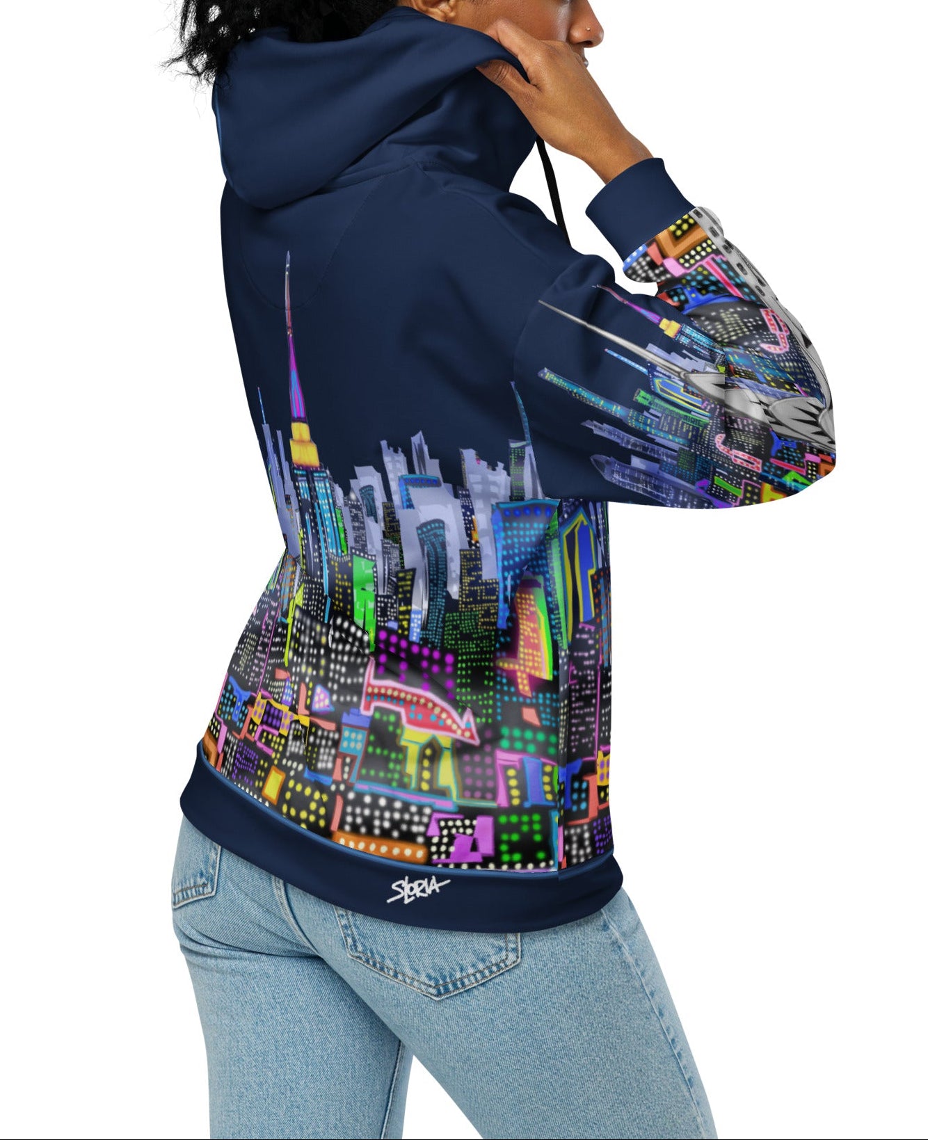 Person wearing a hoodie with a colorful cityscape design by Loria NYC Art on a white background 