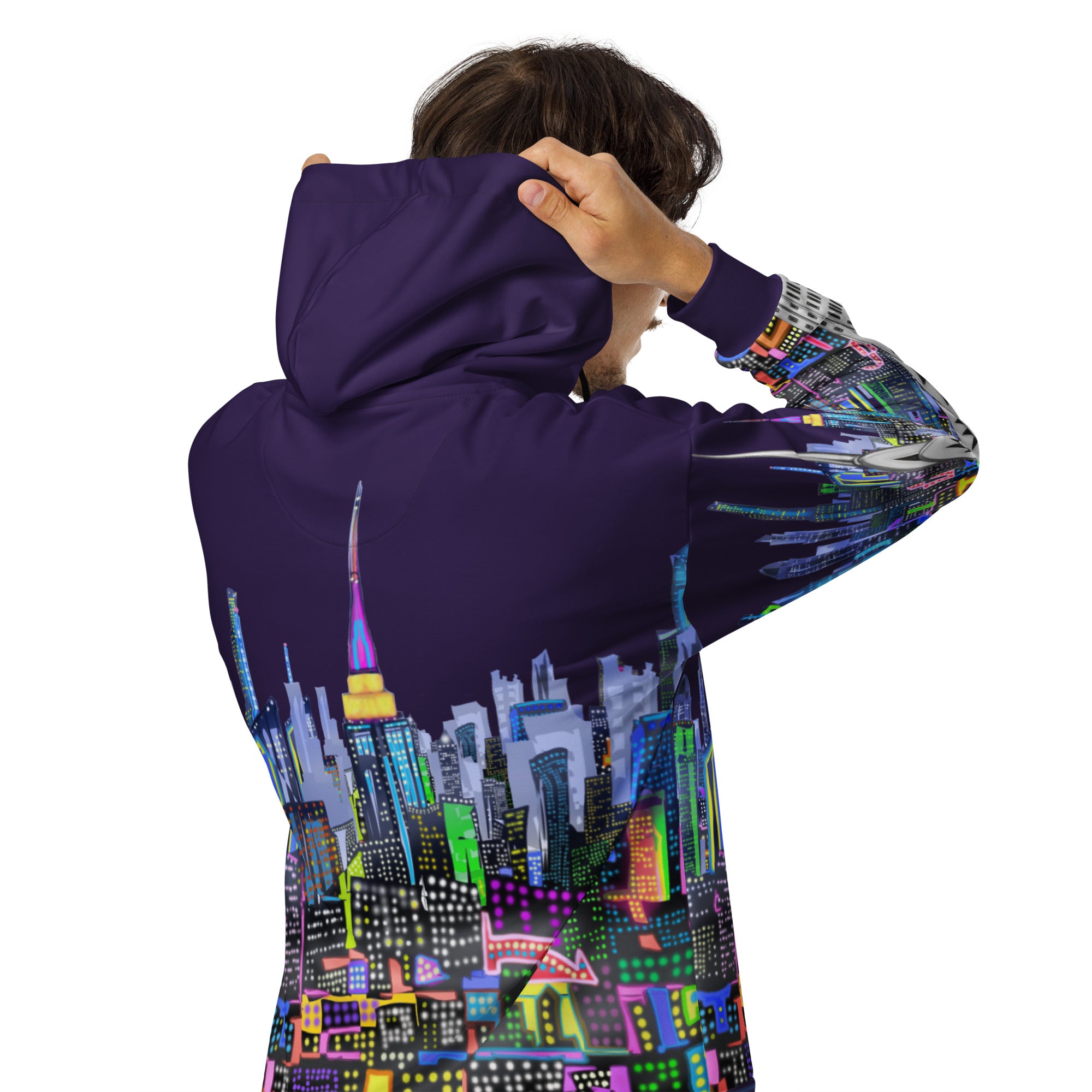 Person wearing a hoodie with a colorful Loria NYC Art cityscape design on a white background