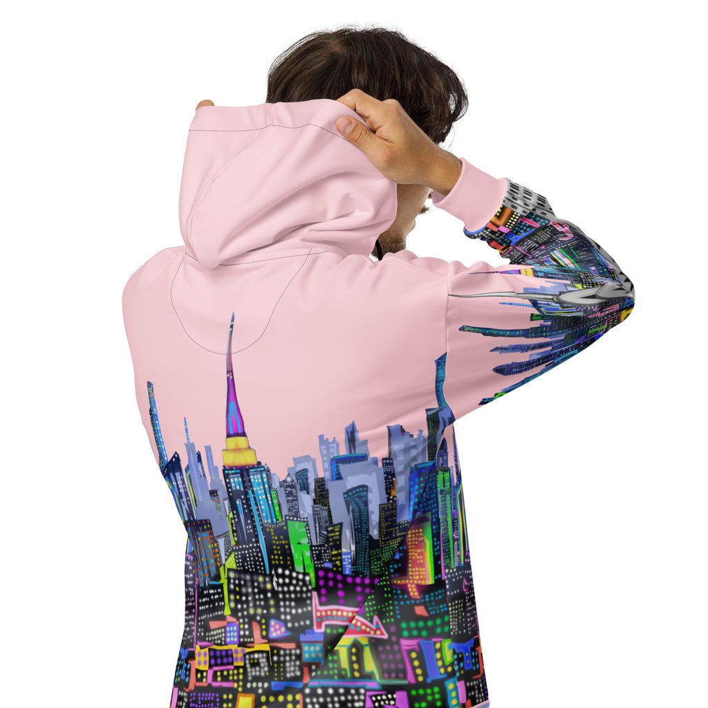 Person wearing a pink hoodie with a colorful cityscape Loria NYC Art design on the back, on a white background.